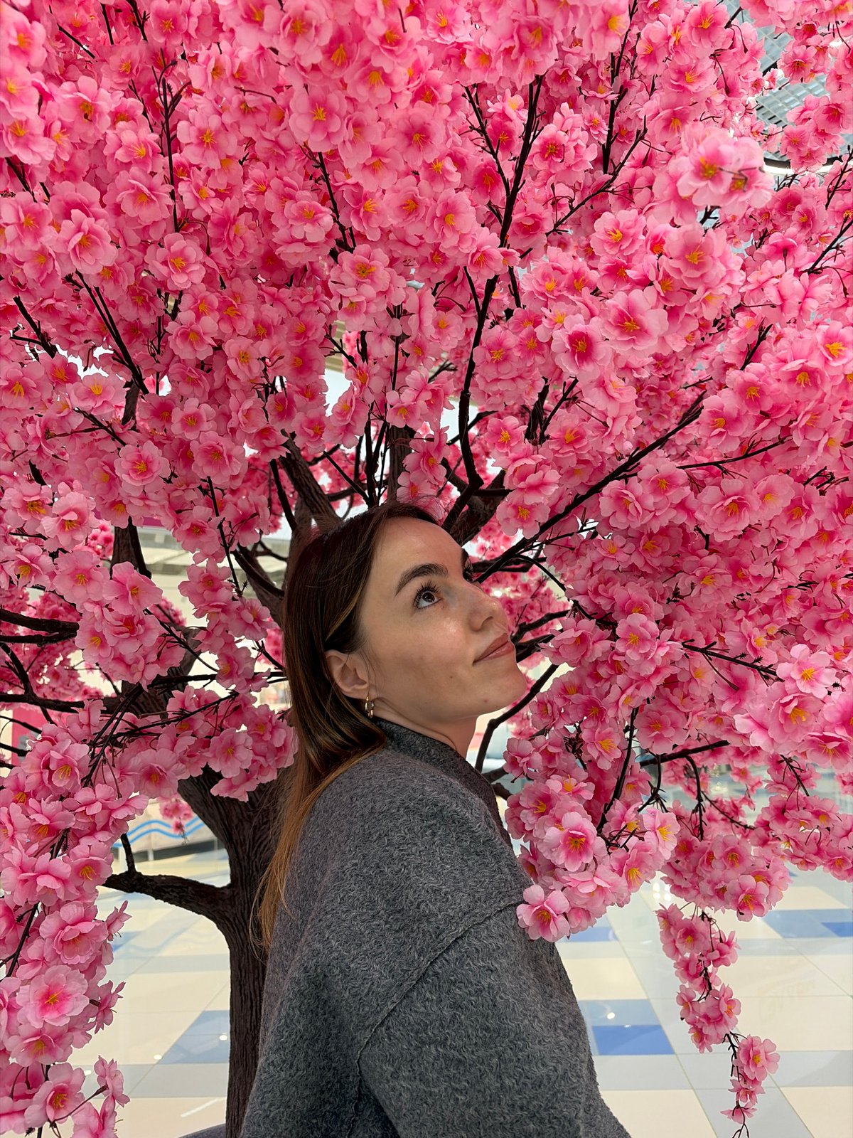 Women pose with cherry blossoms at Izhevsk shopping venue
