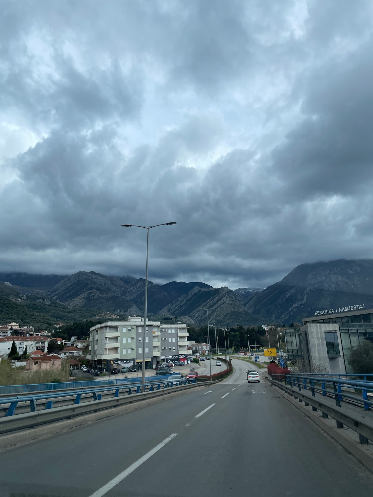 Driver travels elevated roadway in Bjeliši under overcast skies