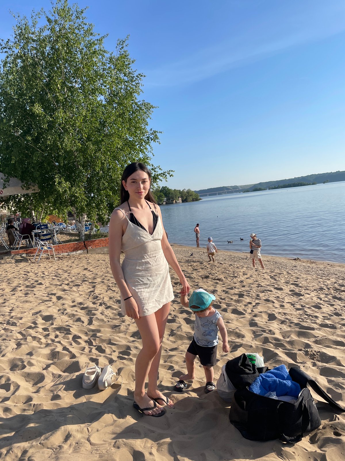 Beachgoers enjoy afternoon sun at Матюшино beach in Russia