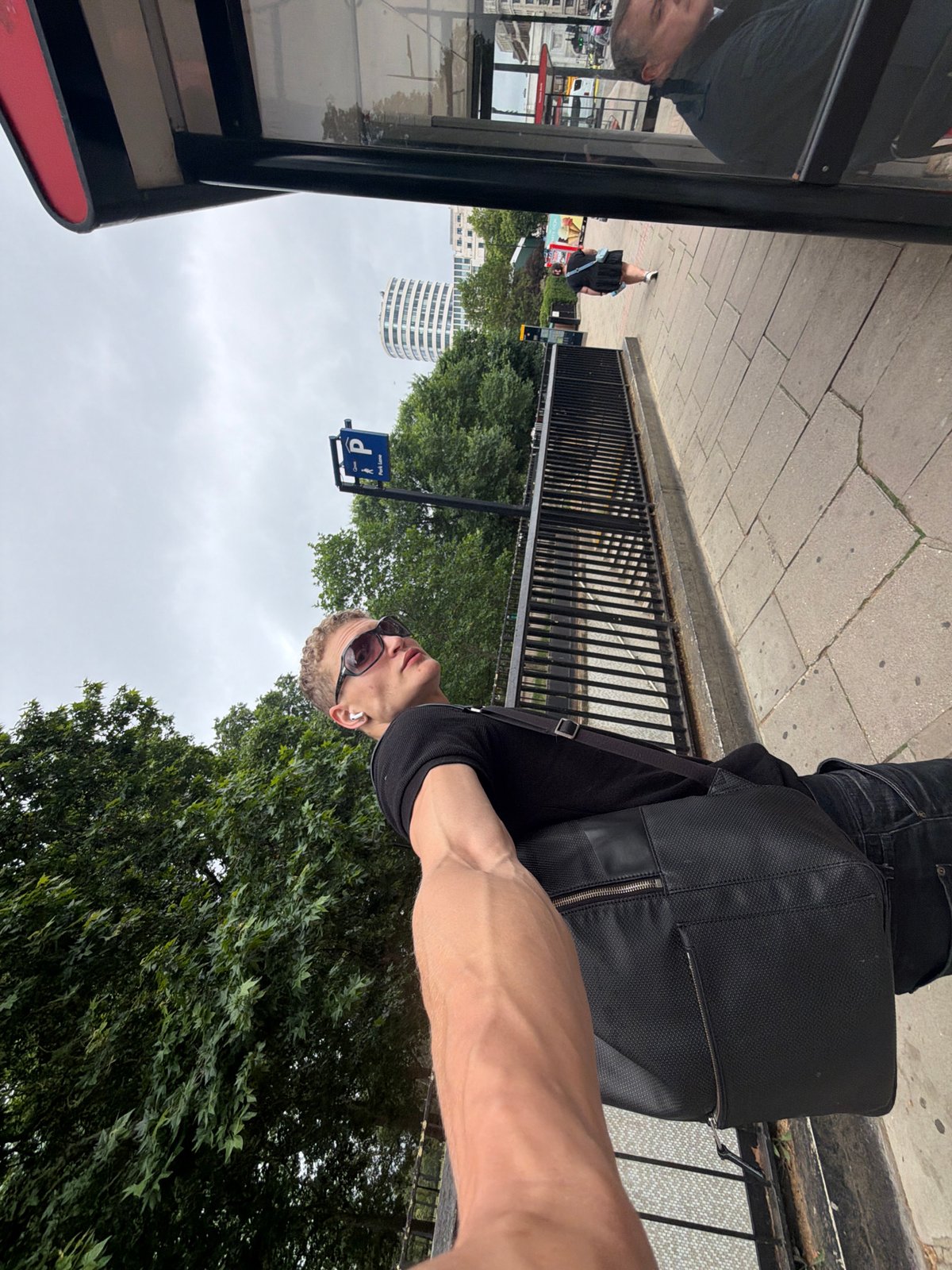 Quiet London bus stop scene under overcast skies