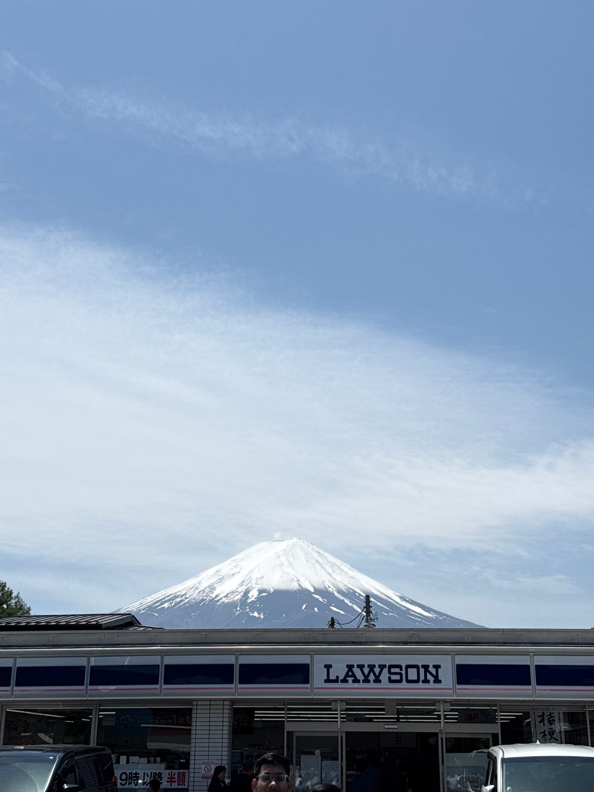 Clear day view of Mount Fuji behind Lawson store