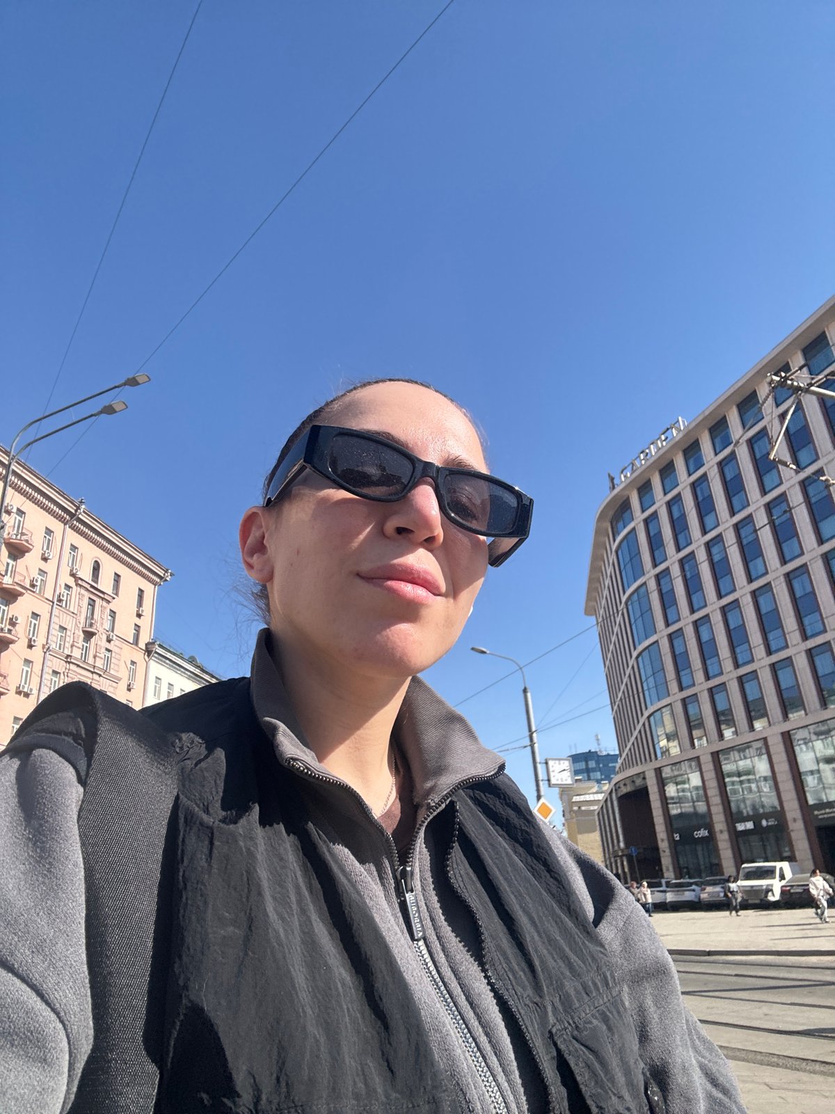 Woman photographed on Moscow street in casual moment