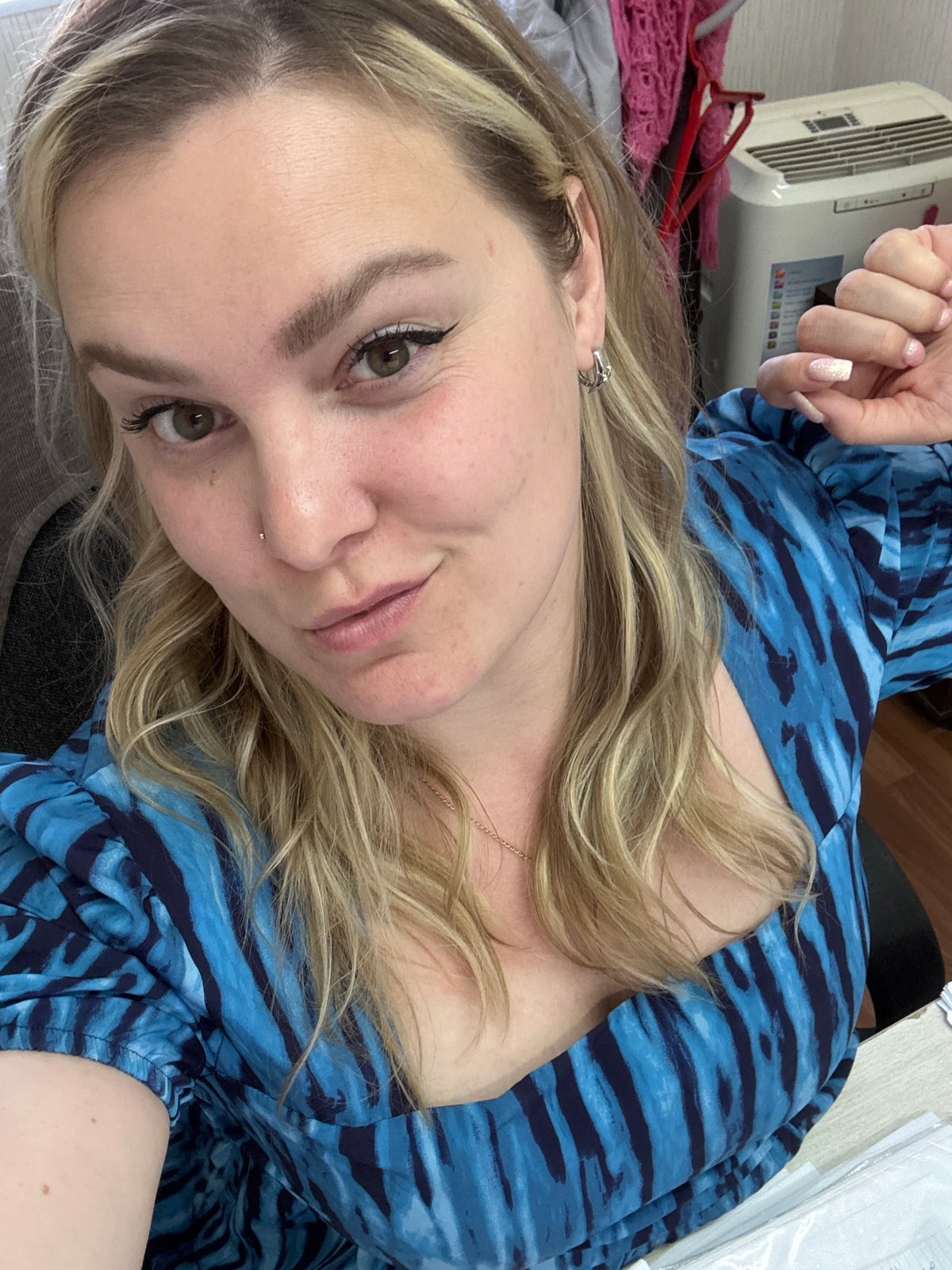 Woman takes selfie in blue dress in Noviy, Russia