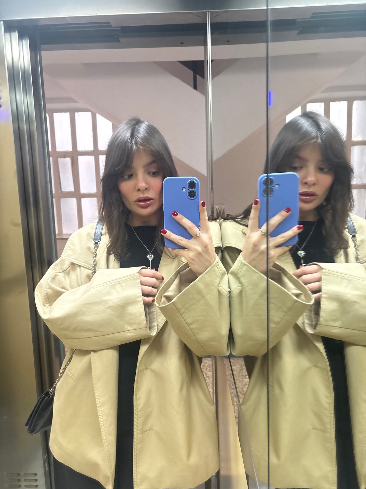 Woman takes mirror selfie in Santiago de Compostela