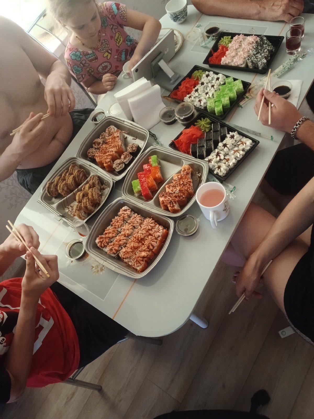 Big sushi spread shared around a well-stocked table