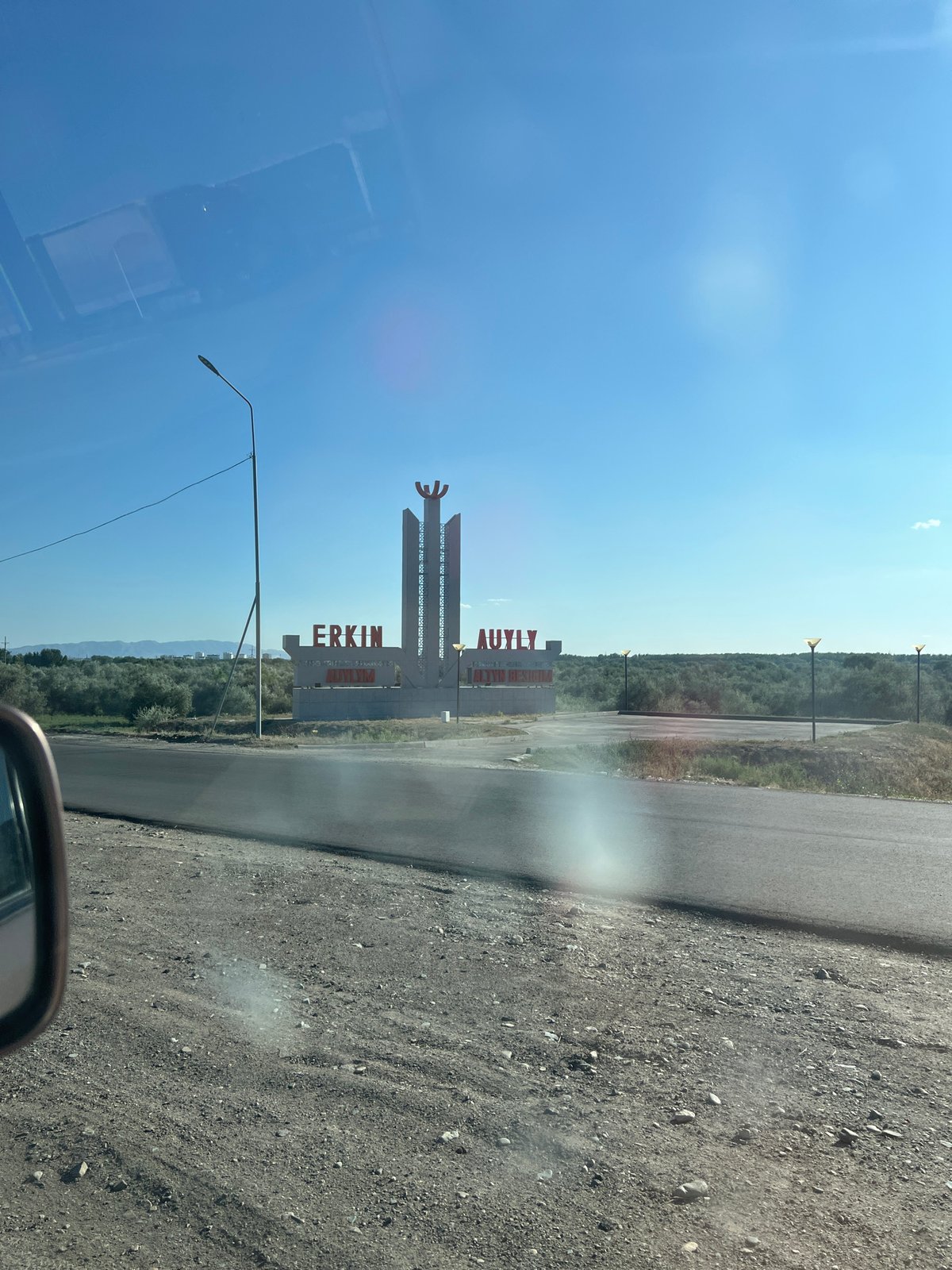 Kazakh flag cap and city monument in Taldykorgan