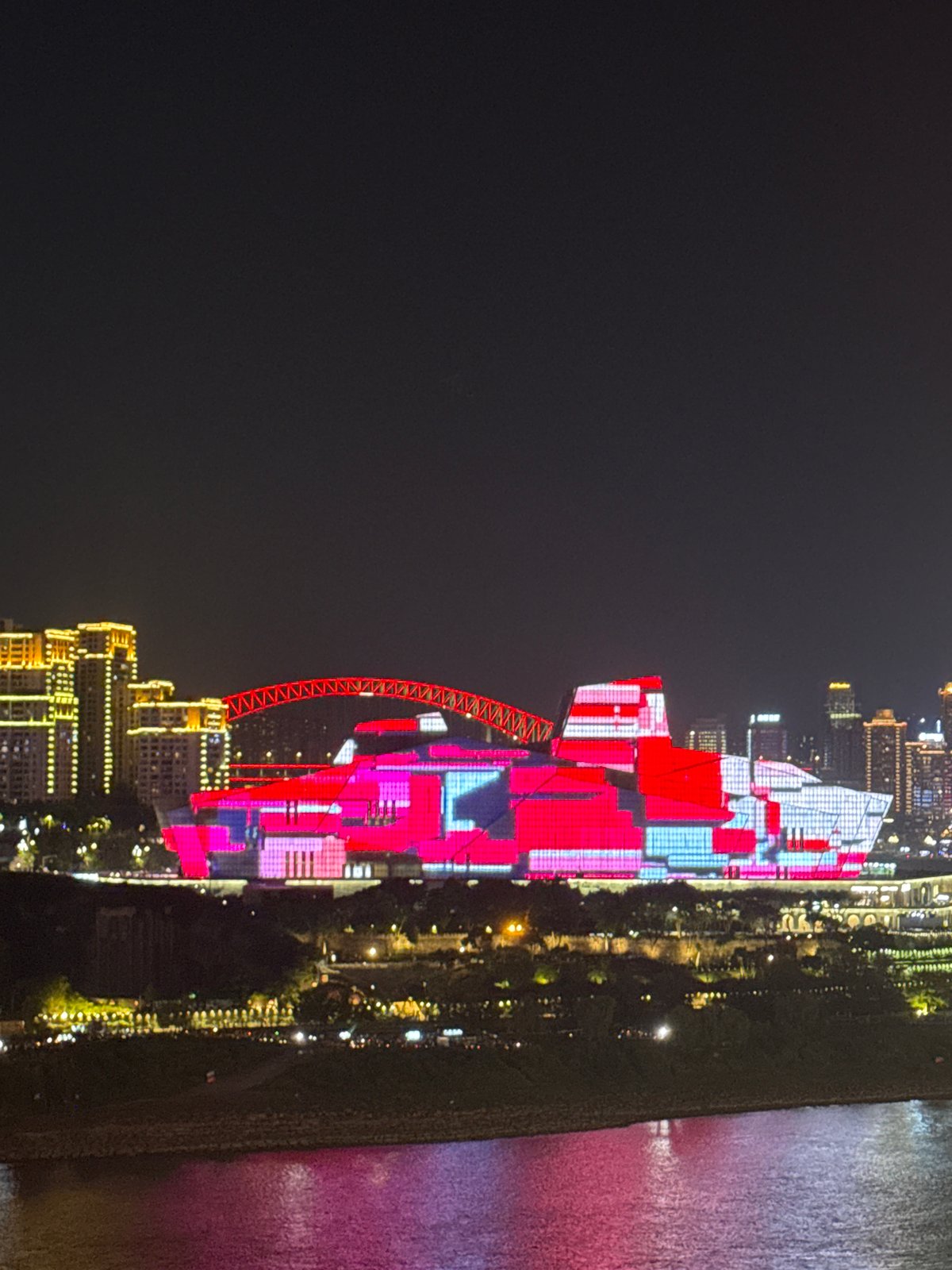 Chongqing's illuminated skyline and bridges captured during afternoon hours
