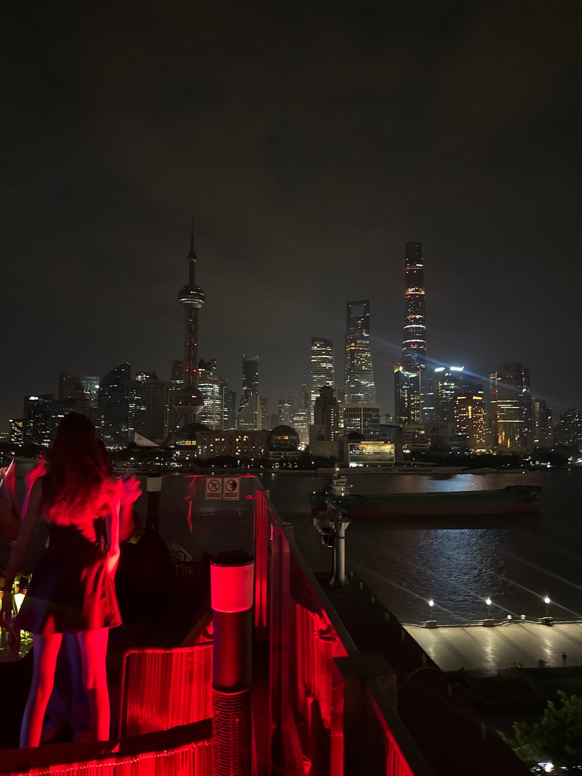 Rooftop party overlooks Shanghai skyline on summer evening
