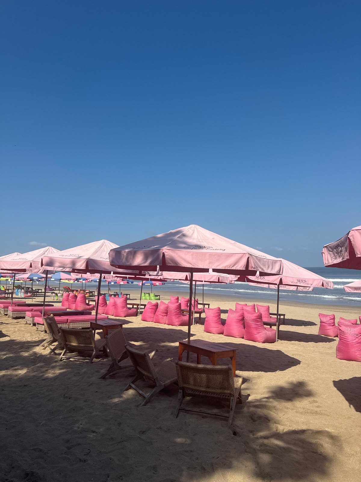 Kuta Beach scene: umbrellas, surf, and beachside bar