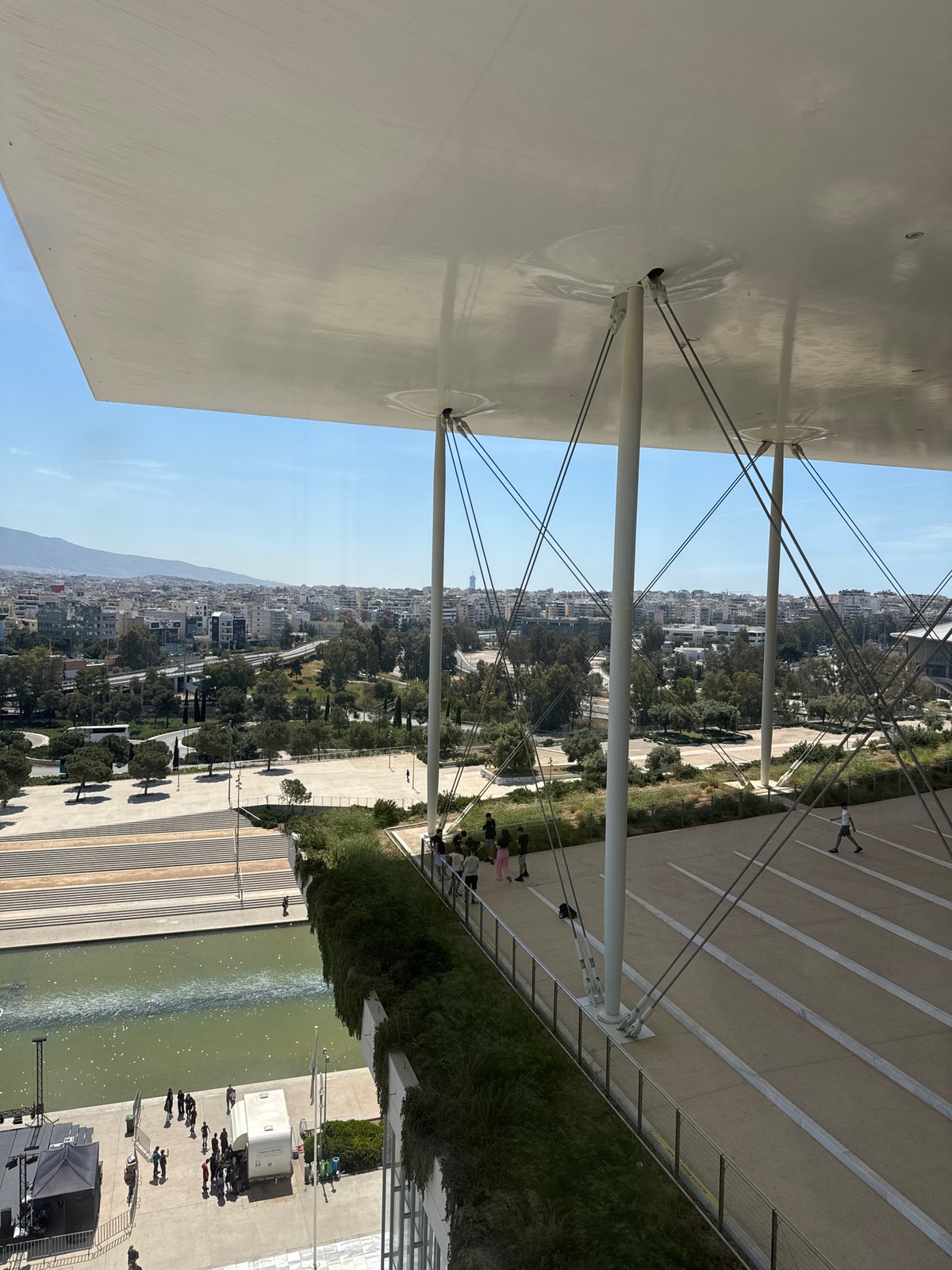 Visitor documents modern Athens cultural center architecture morning tour