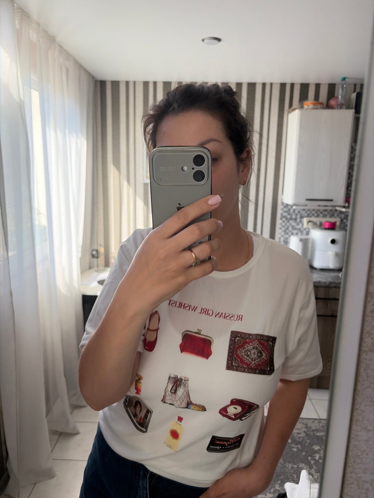 Woman takes selfie series in "Russian Girl Wishlist" shirt in Sochi