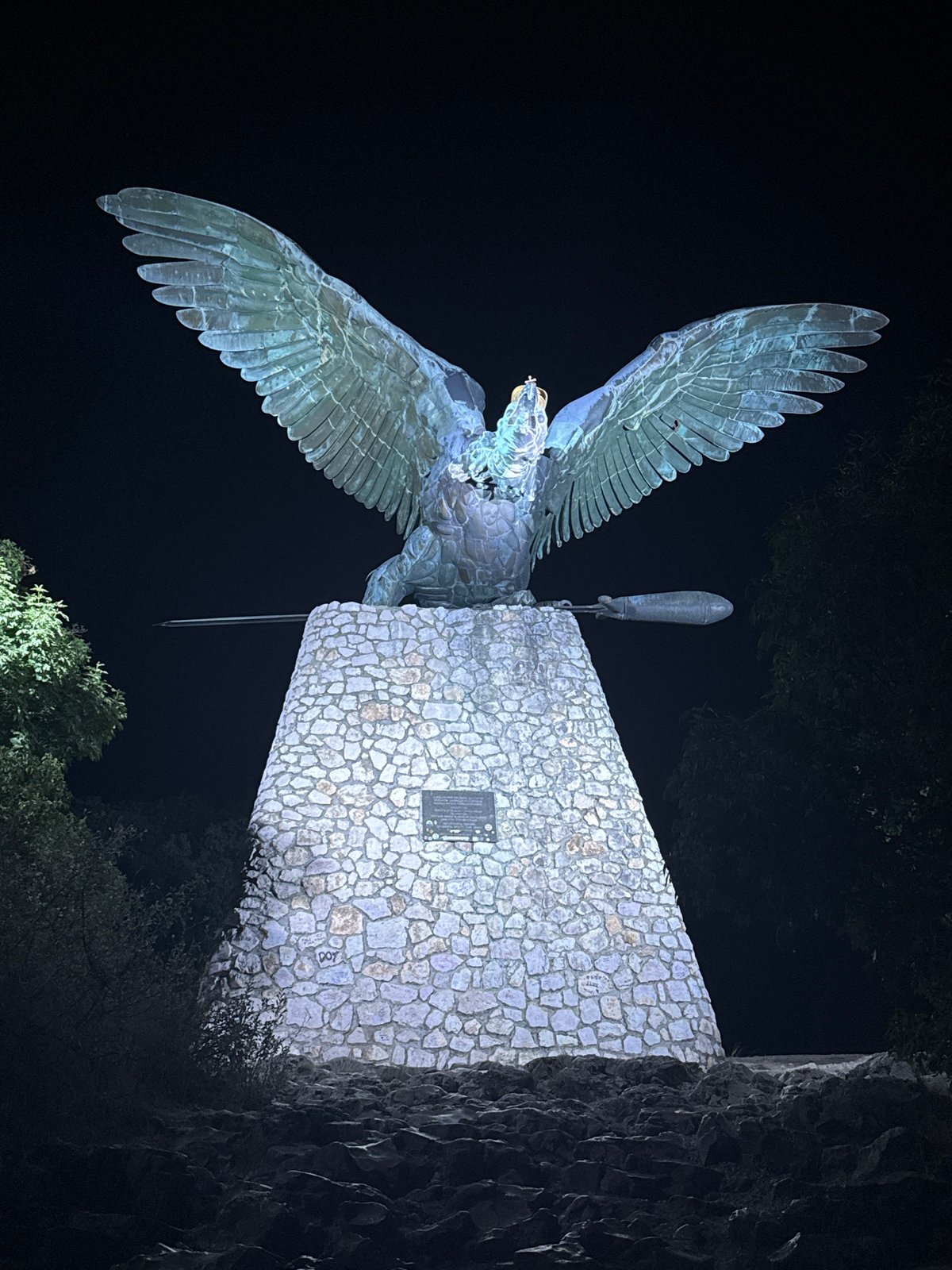Bronze eagle monument illuminated at night