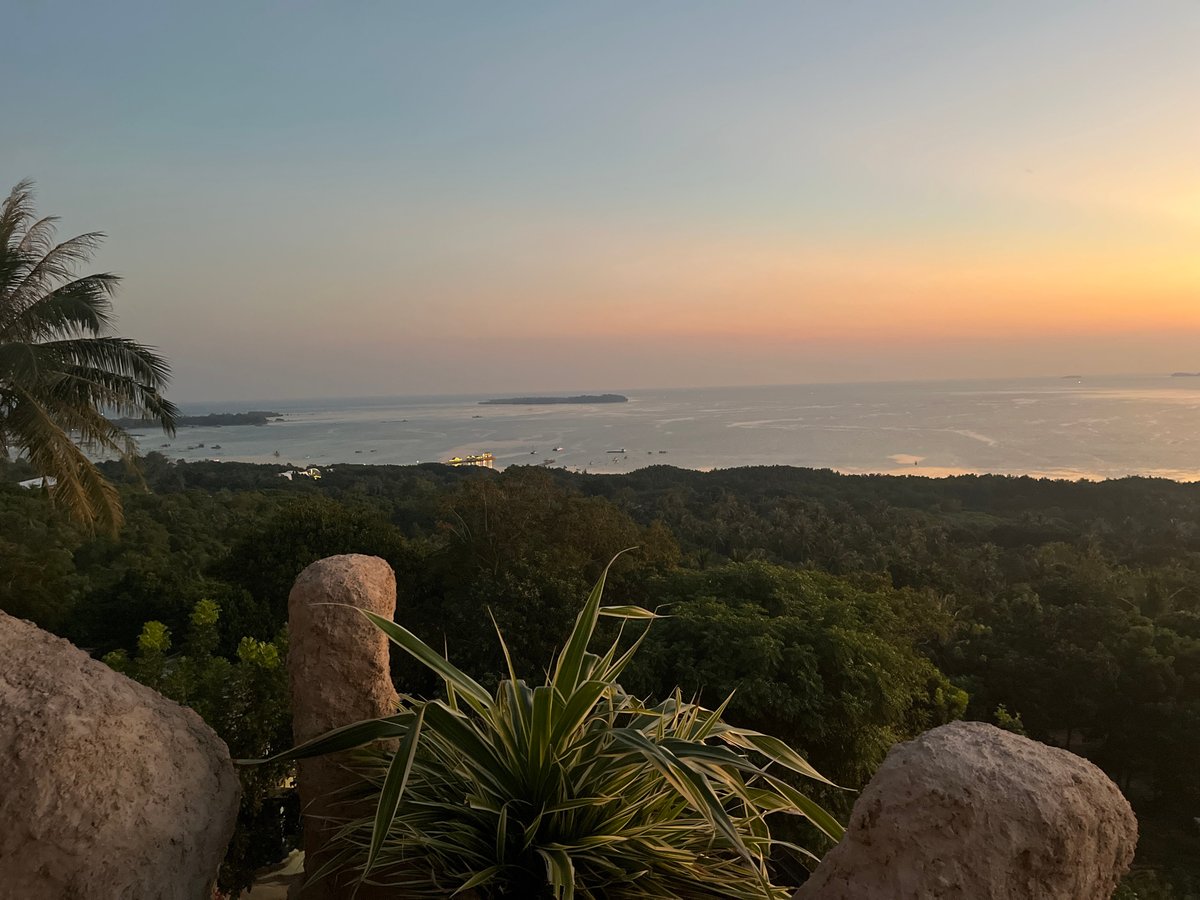 Golden hour across Karimunjawa's rocks, coastline, and hills