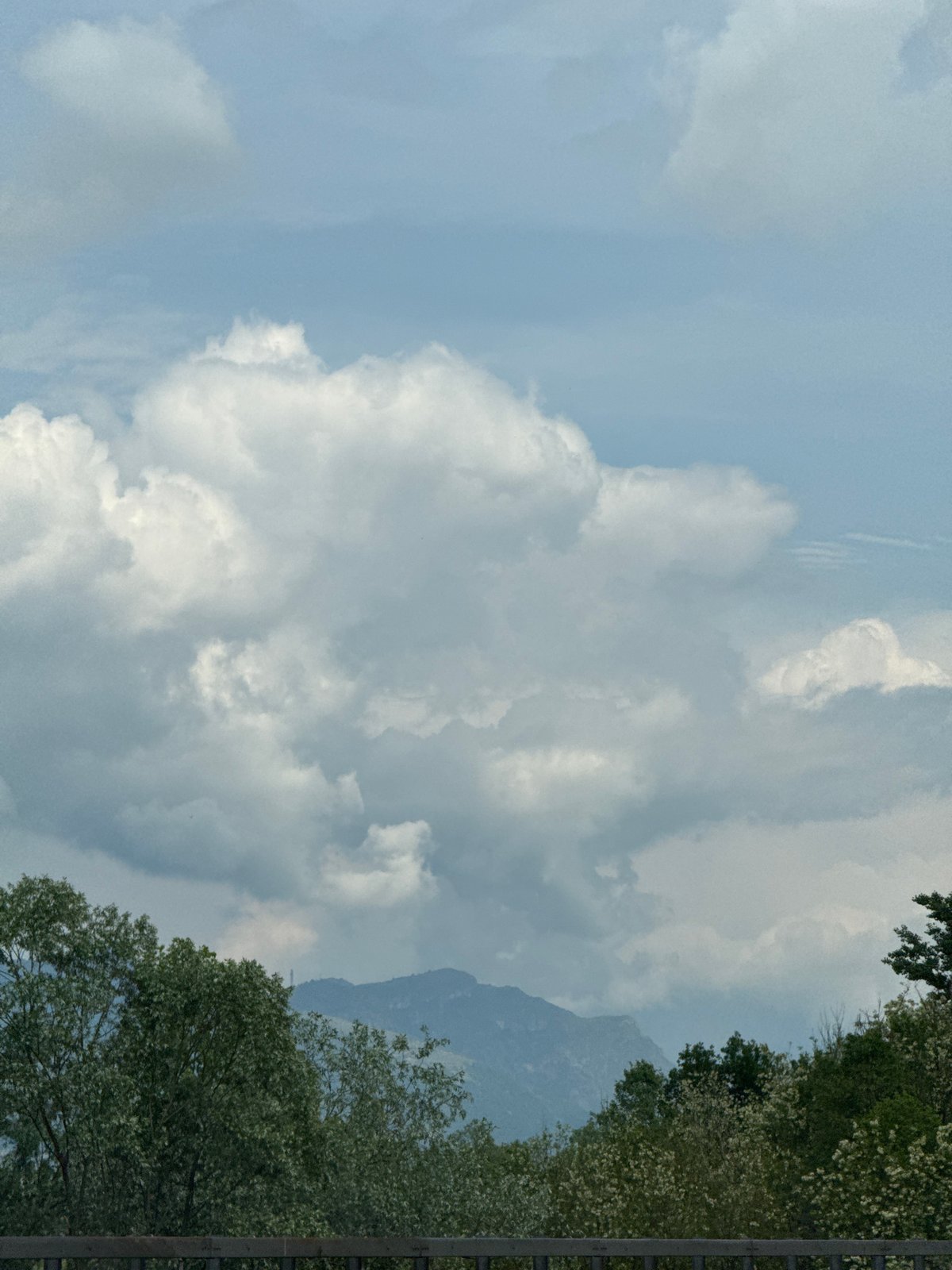 Partly cloudy mountain landscape observed in Briosco, Italy