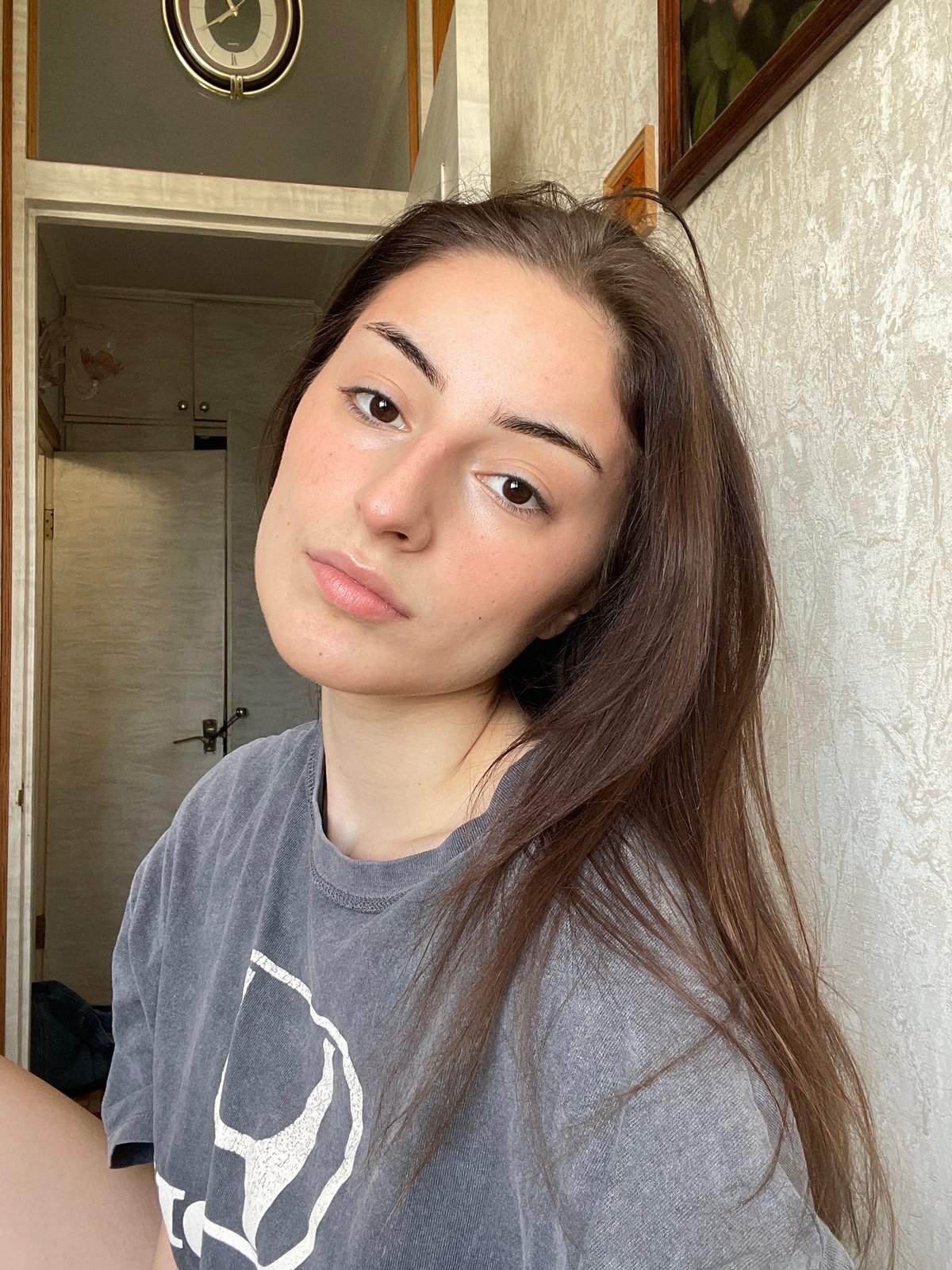 Woman applies facial cream during morning routine in Moscow