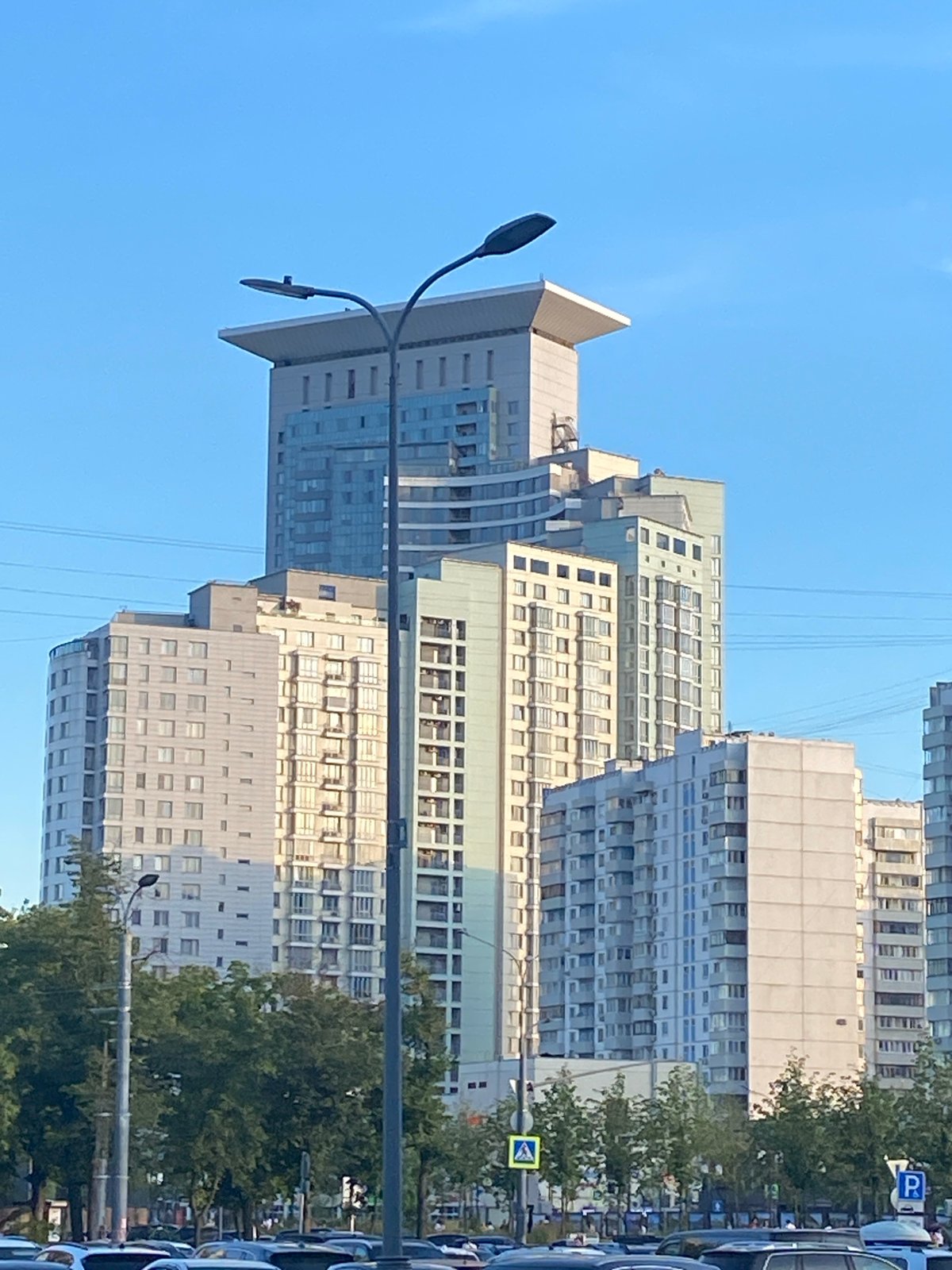 Modern residential towers line a Moscow street on a clear day