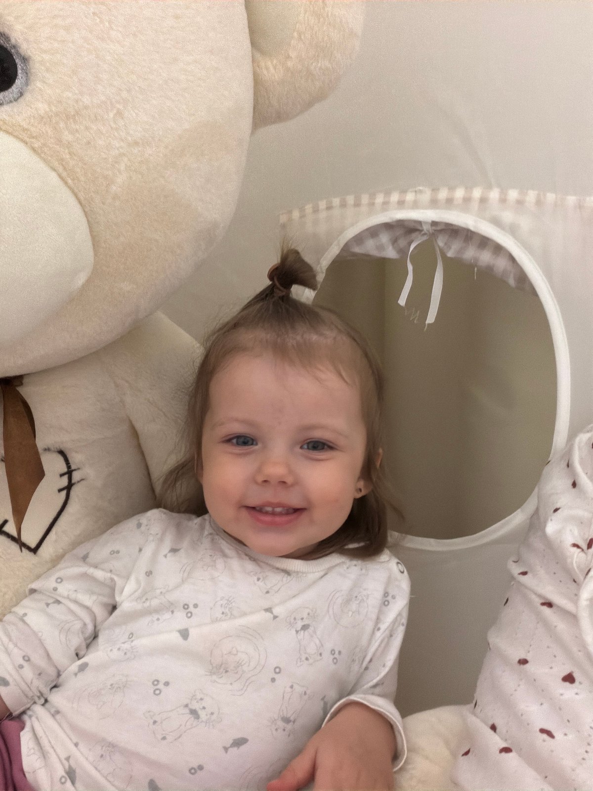 Toddler plays with teddy bear in Reshetnikovo home