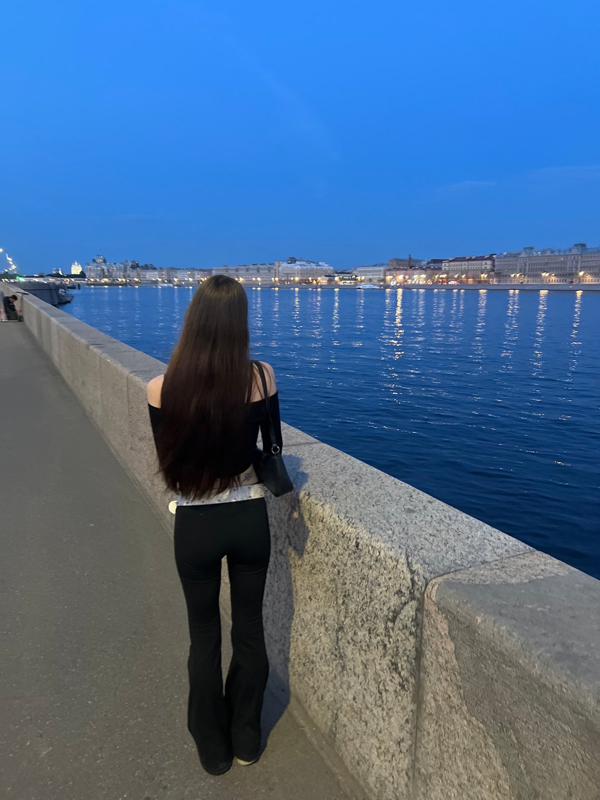 Evening stroll documented near Finland Station waterfront at dusk
