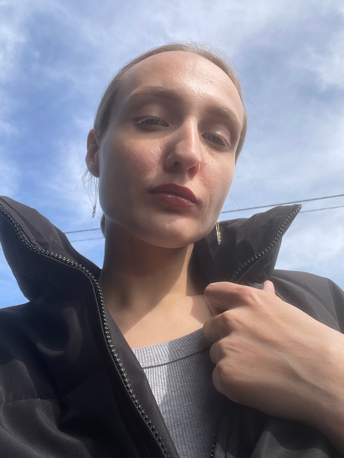 Woman takes selfie, tulips bloom in Russian village garden