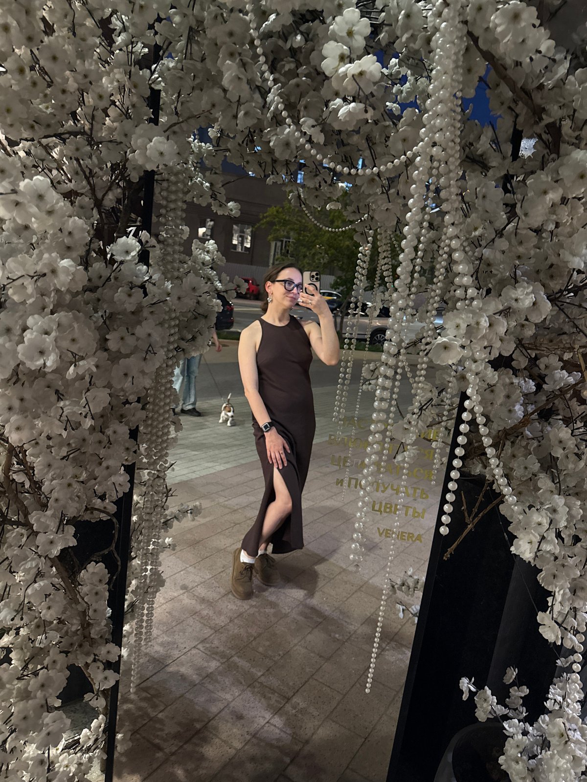 Woman photographed near decorated flower shop in Khimki, Russia