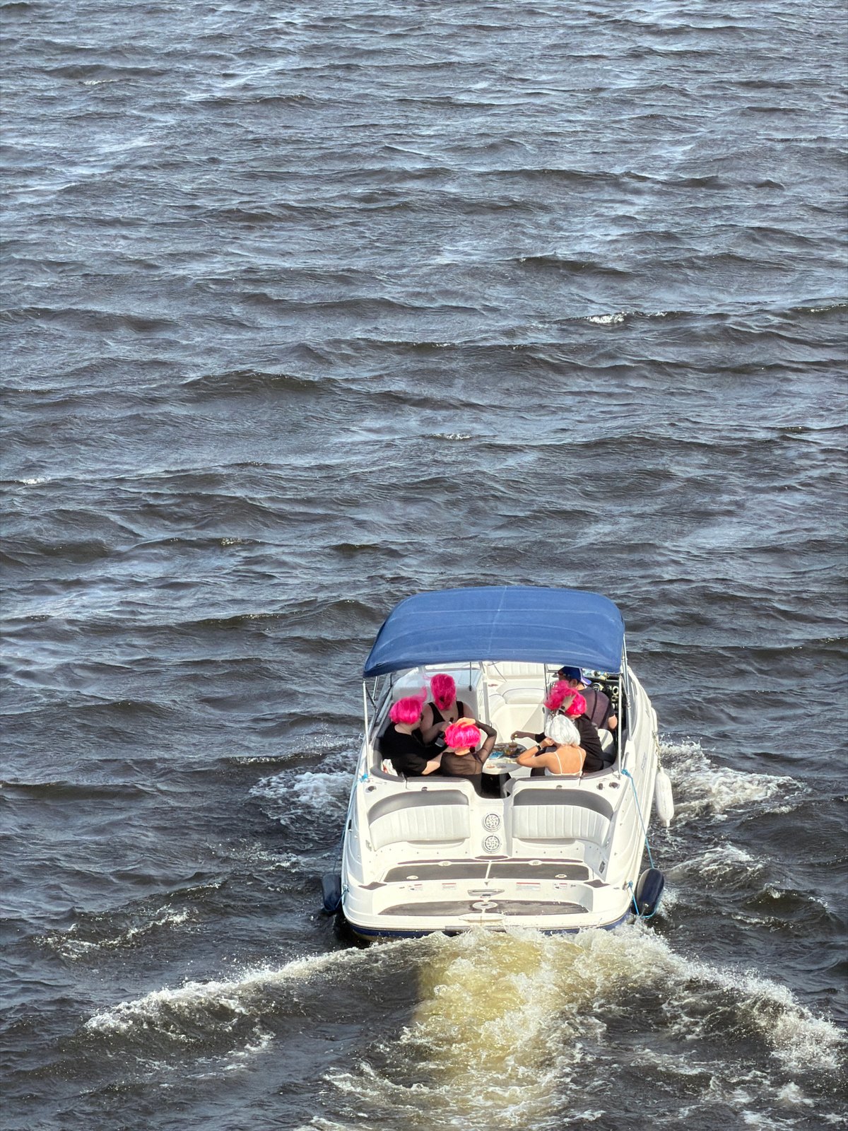 Motorboat navigates Neva River in Saint Petersburg during afternoon