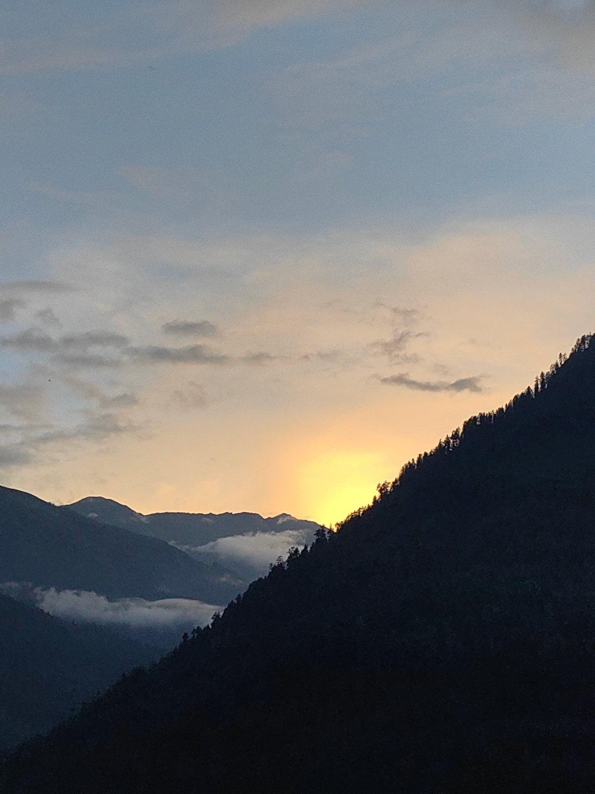 Golden hour over the forested mountains of Vashisht, India