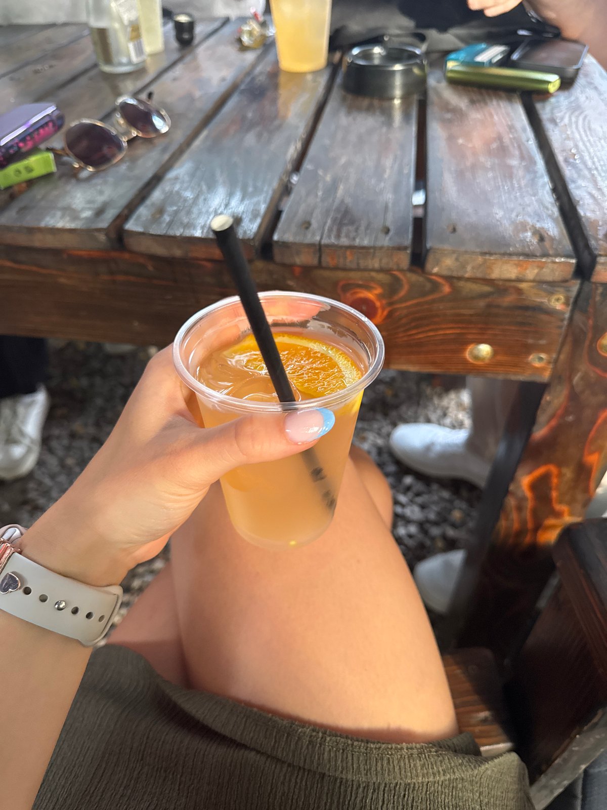 Outdoor festival in Sofia's pine trees with drinks and a stage