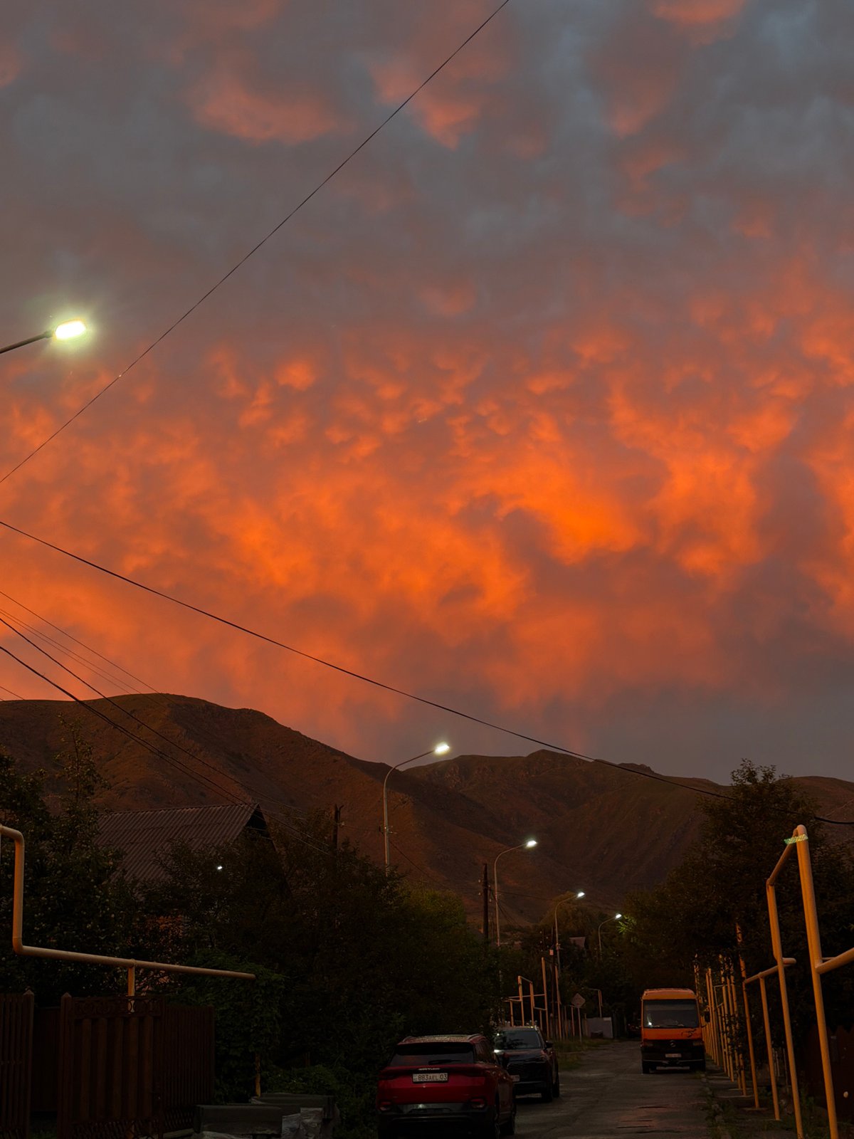 Fiery sunset sky over a quiet street in Tekeli, Kazakhstan