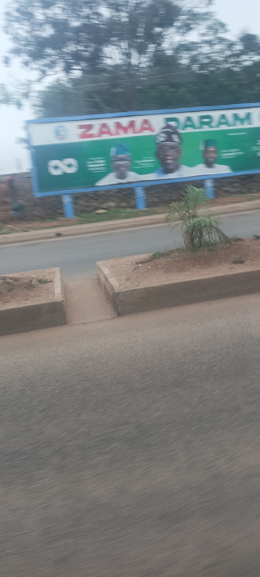 Moving vehicle captures Jos street scenes including gas station