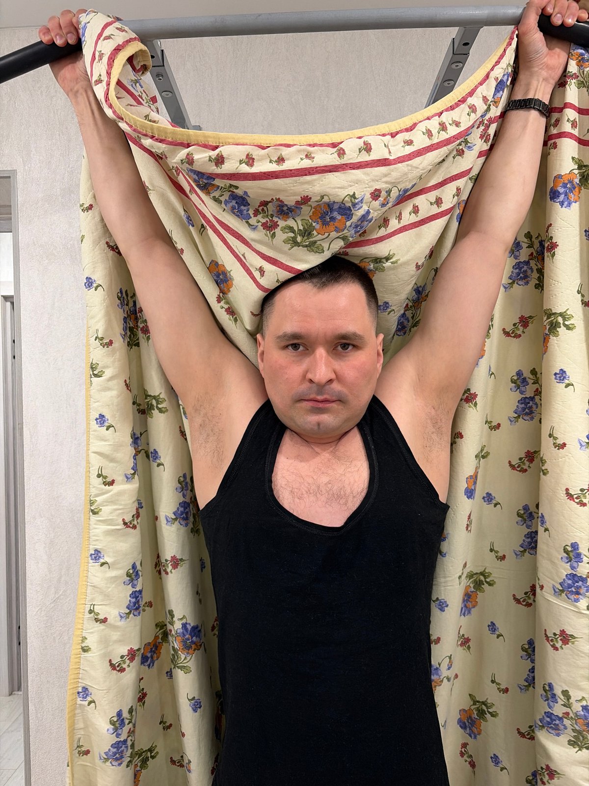 Man relaxes in bedroom with exercise equipment in Sarapul