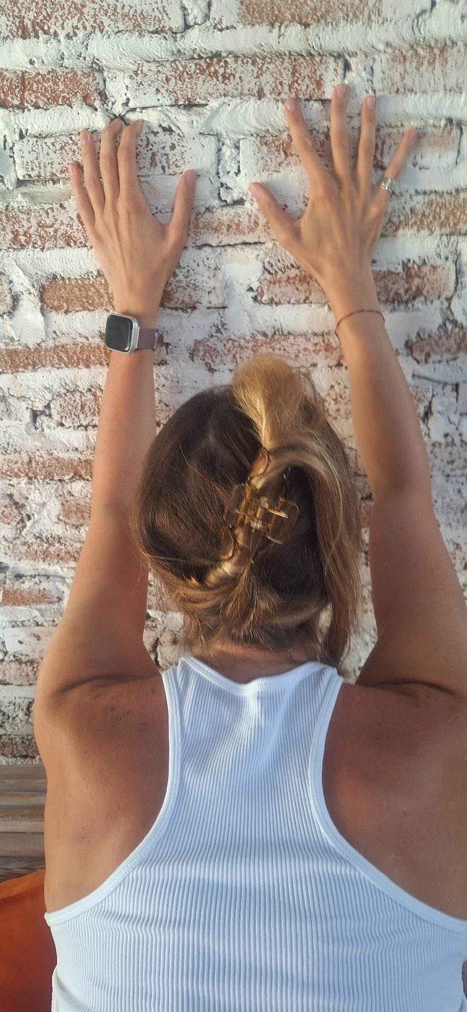 Hands pressed against a white wall in Kuta Selatan