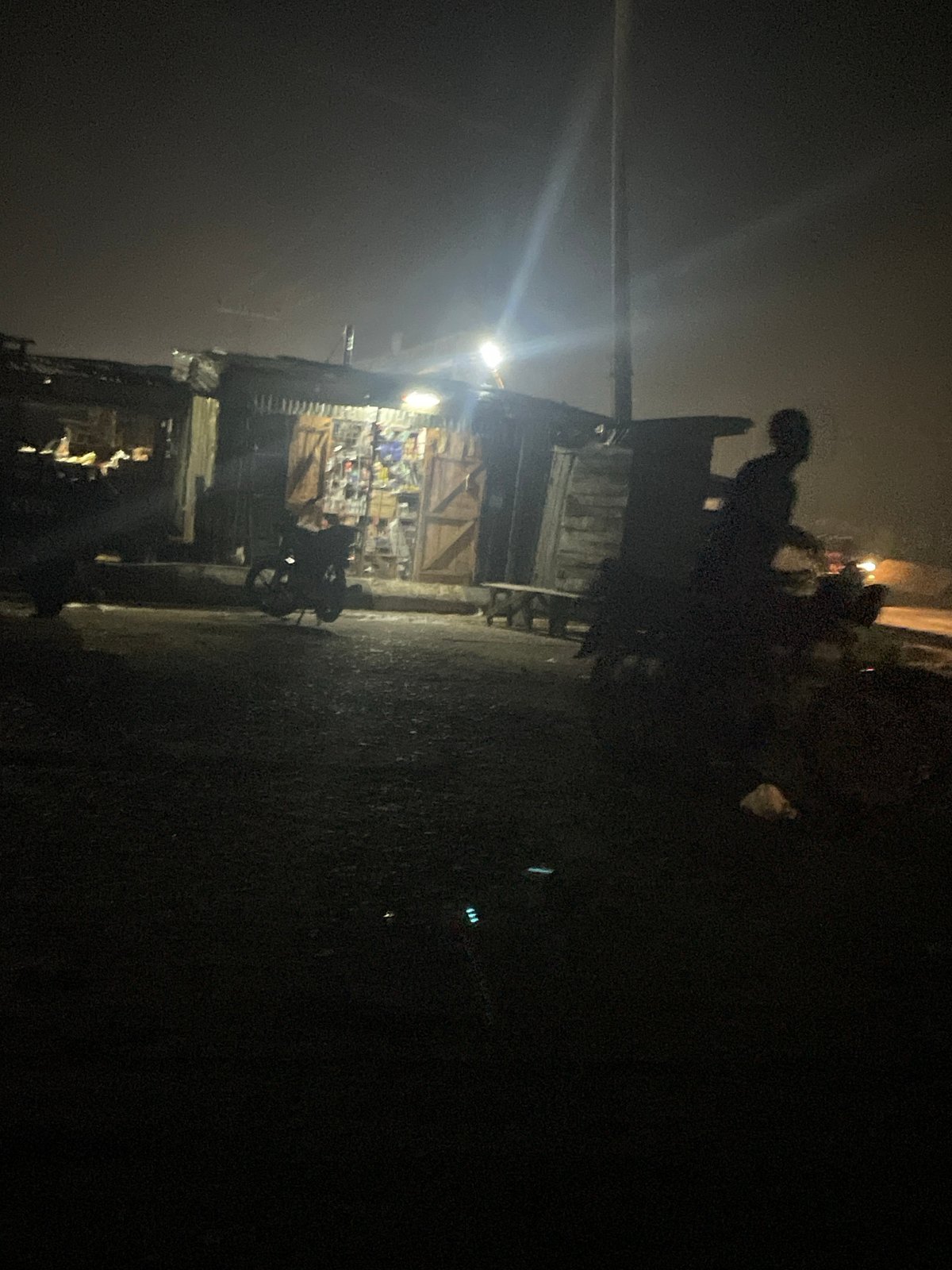 Night traffic and roadside activity along a Lokoja highway