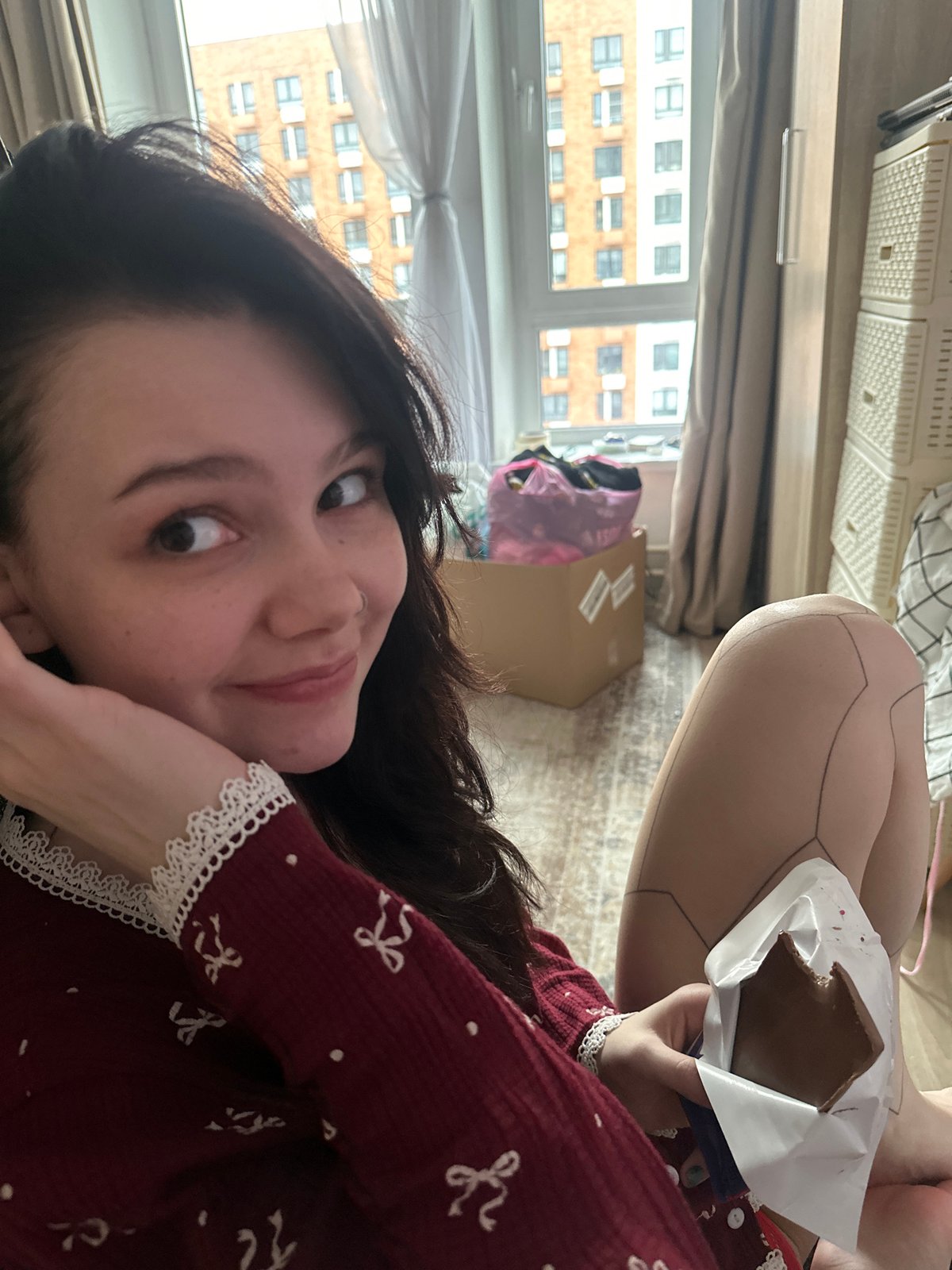 Woman enjoys chocolate snack in Lyubertsy apartment