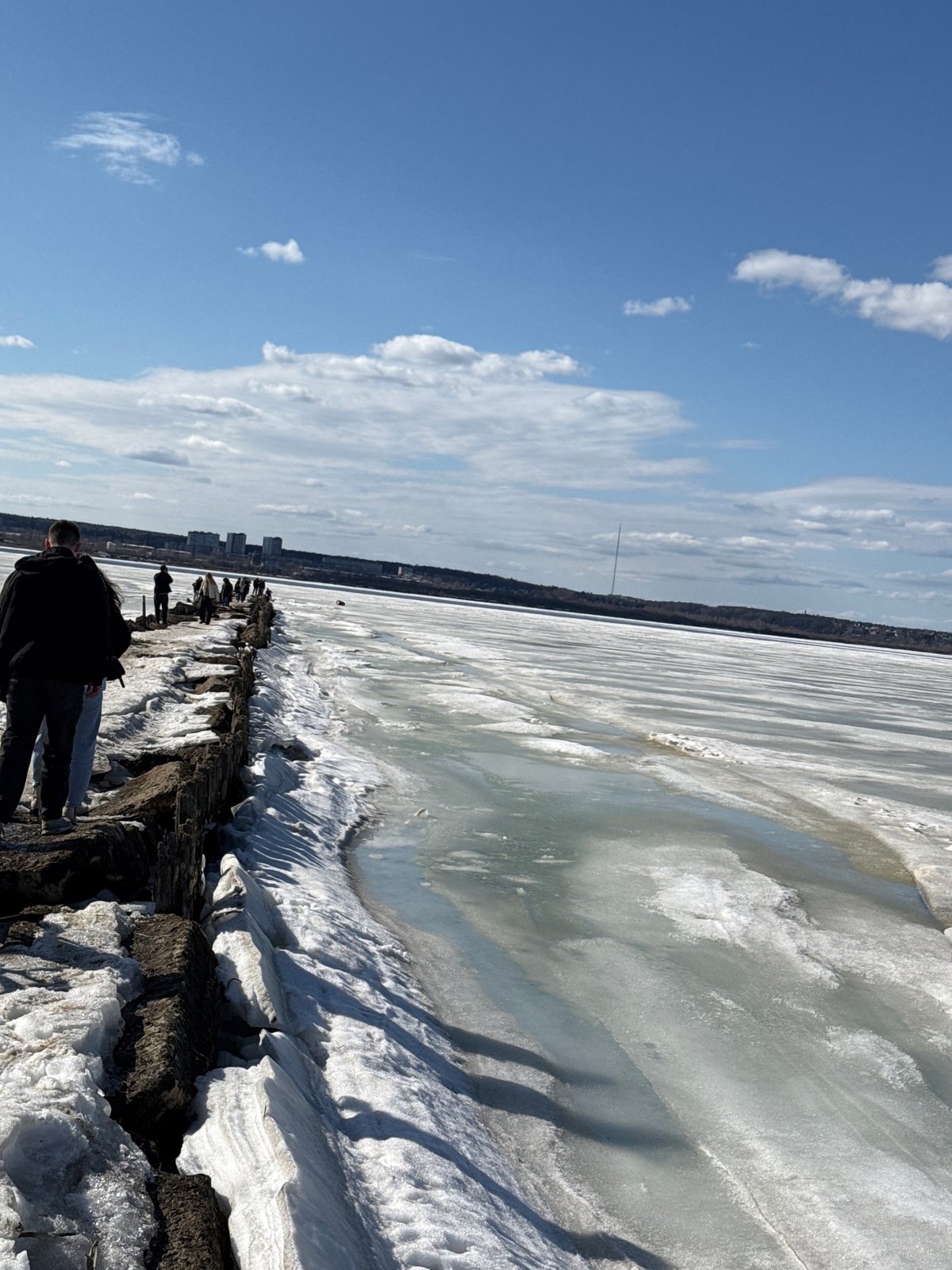 Woman photographs spring ice conditions along Izhevsk waterfront