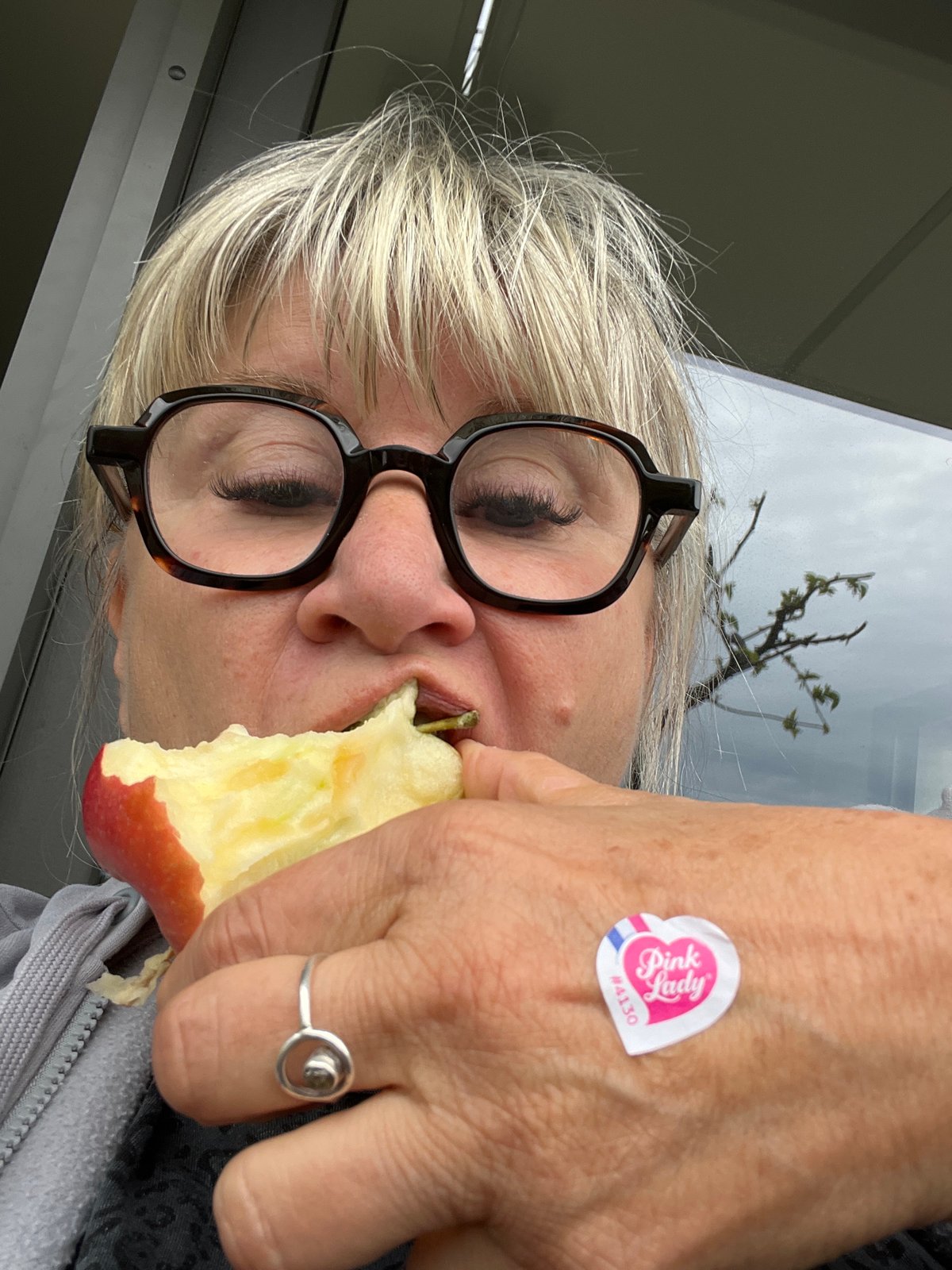 Woman eating apple photographed in Chambœuf, France