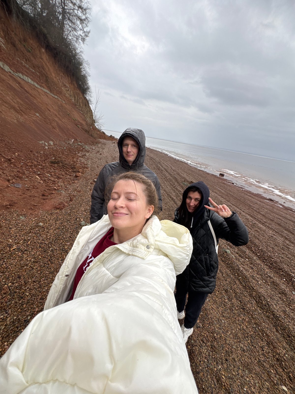 Three people photograph beach outing in Chaikovsky, Russia