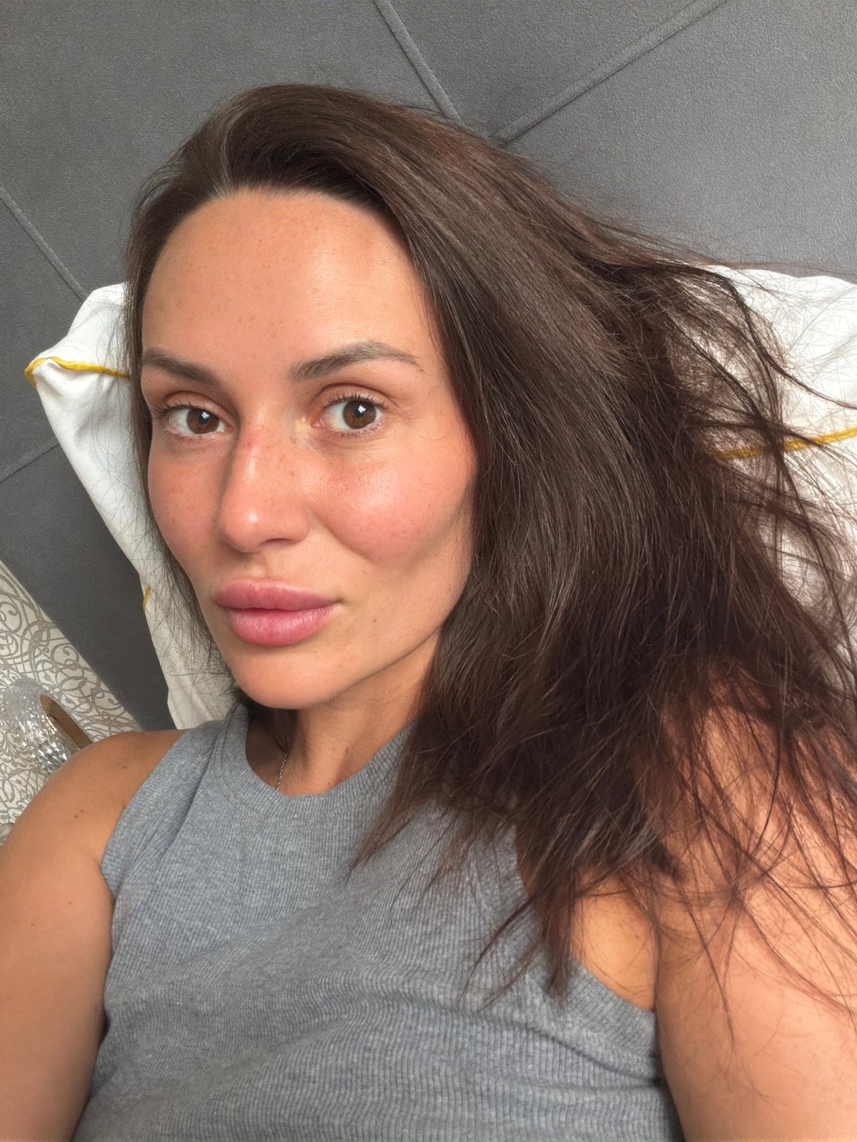 Lazy morning selfie session on a grey bed in Moscow