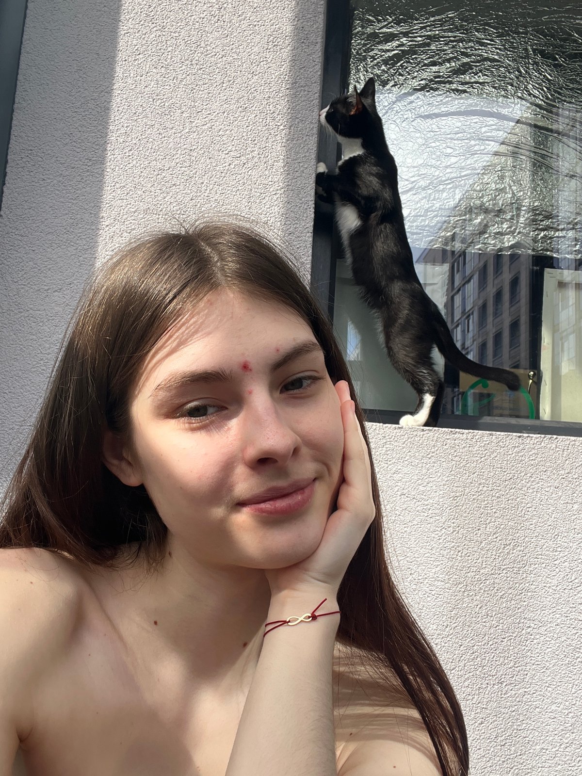 Woman takes selfies with black and white cat in Saint Petersburg