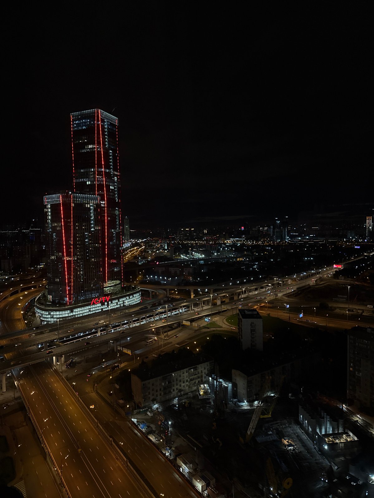Aerial nighttime views of a city skyline anchored by ICITY towers