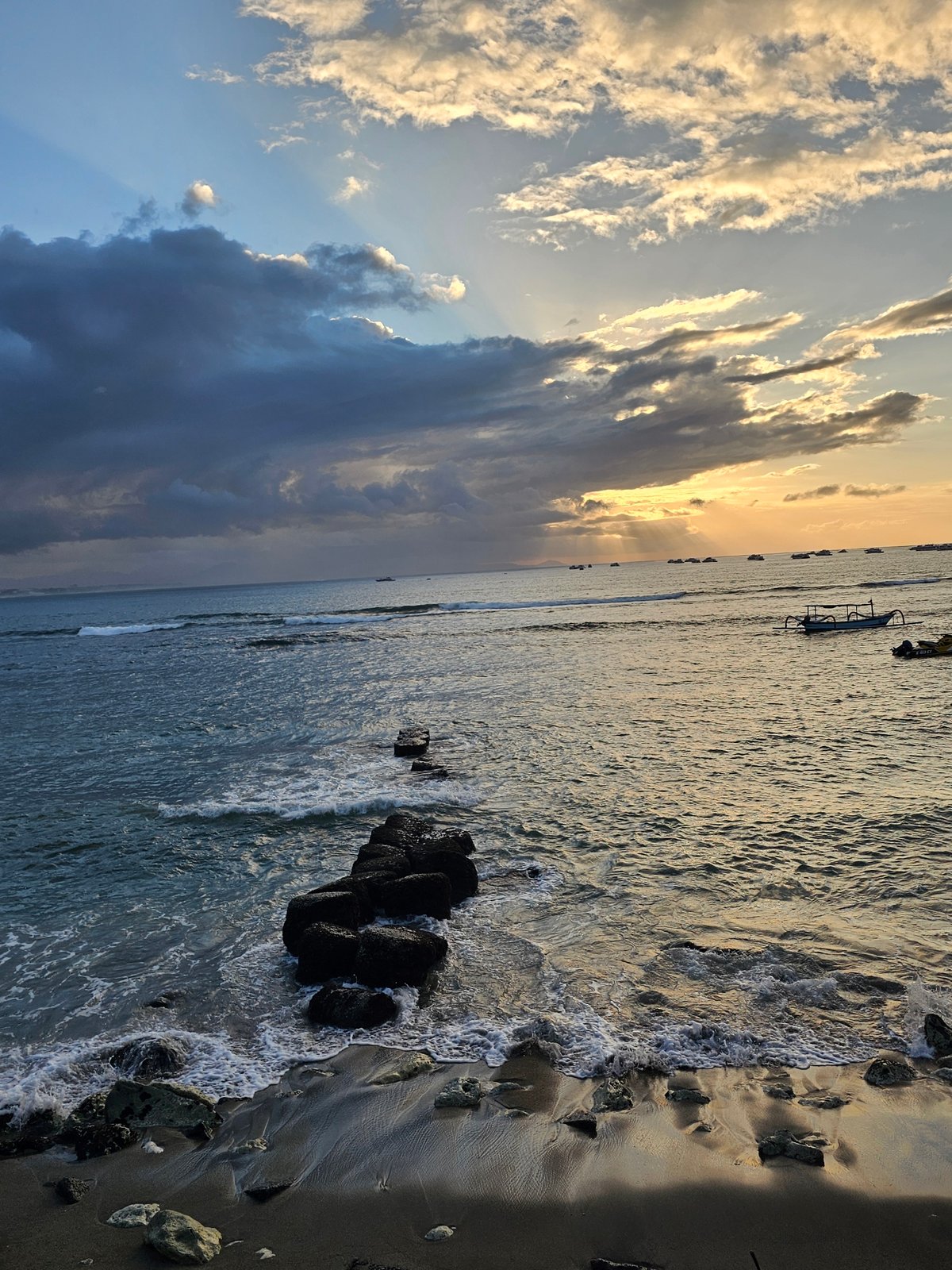 Sunset along the Denpasar waterfront, ferries and coastal views