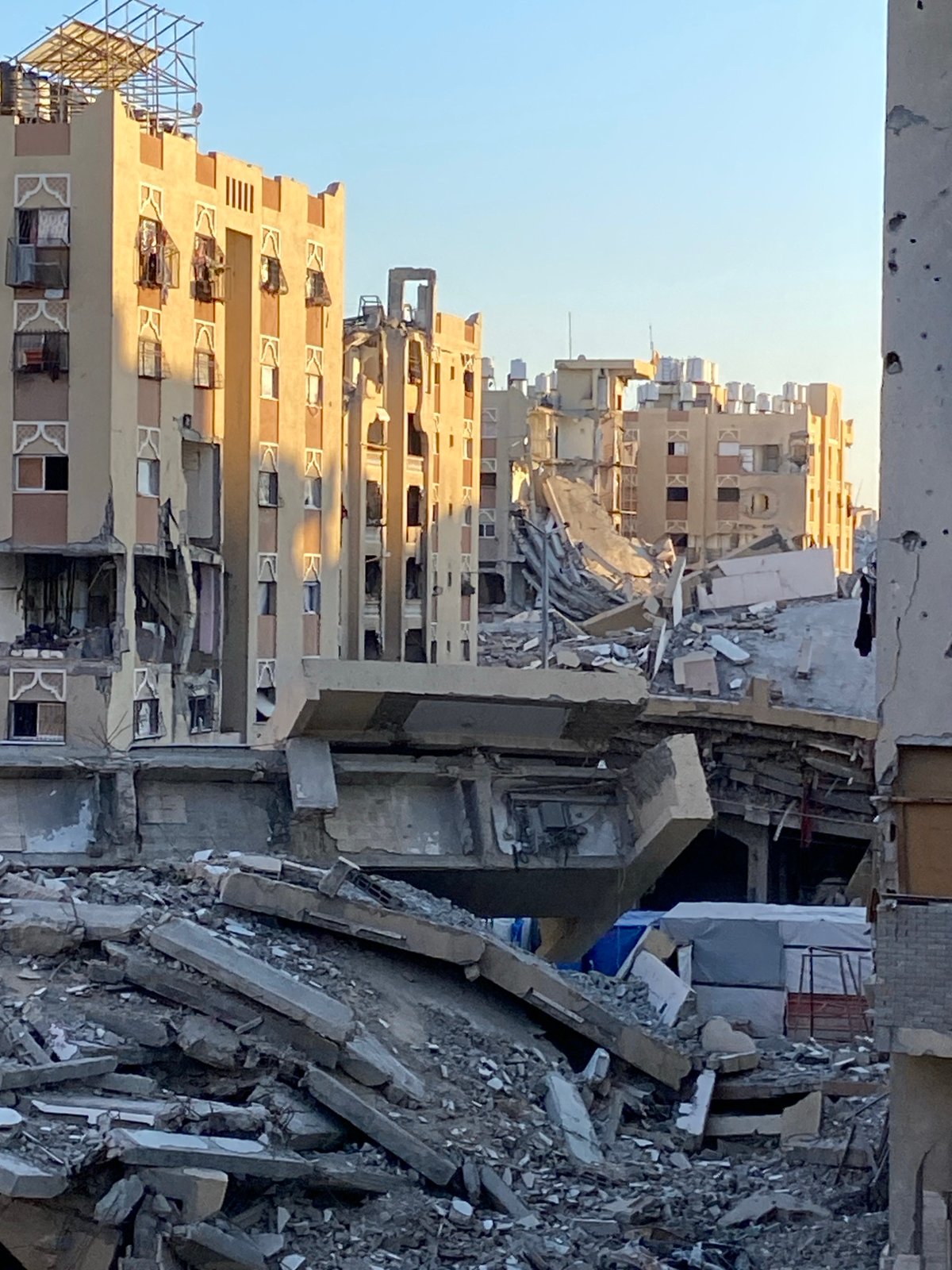 Witness documents damaged buildings, shelters in Khan Yunis