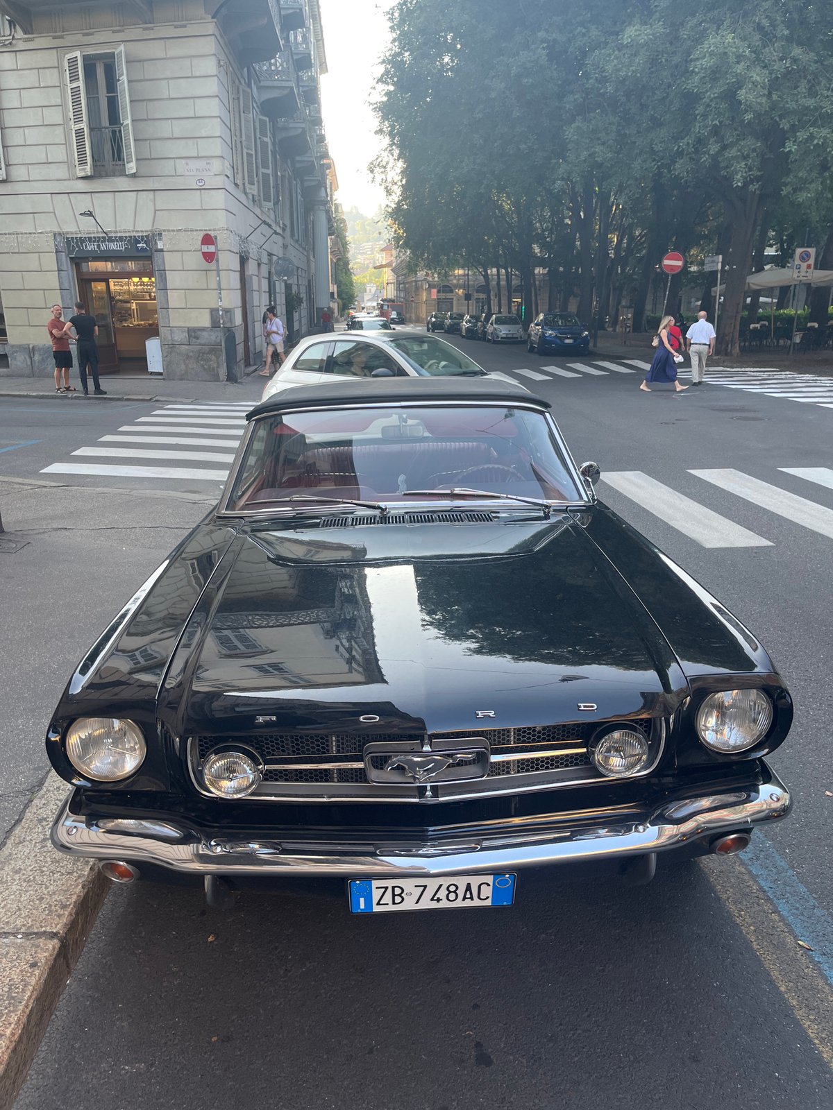 Classic black Mustang convertible parked on a Turin street