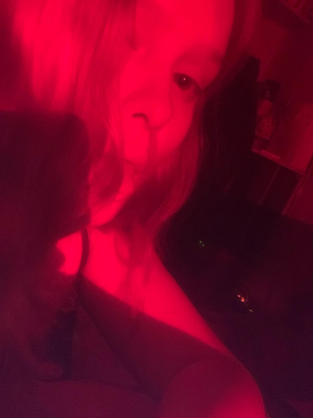 Red-lit portraits and prop sword documented in Russian suburb