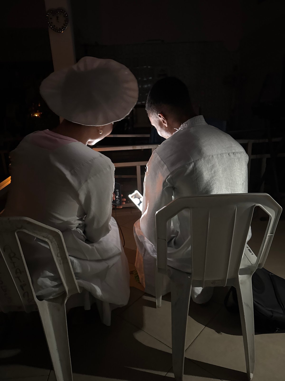Nighttime ceremonial gathering in white attire, Badagry Nigeria