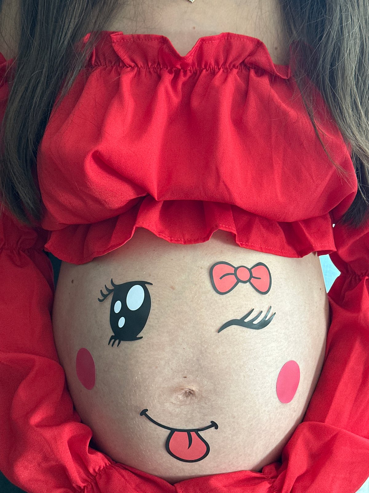Pregnant woman celebrates with belly art and chocolate in Wisła