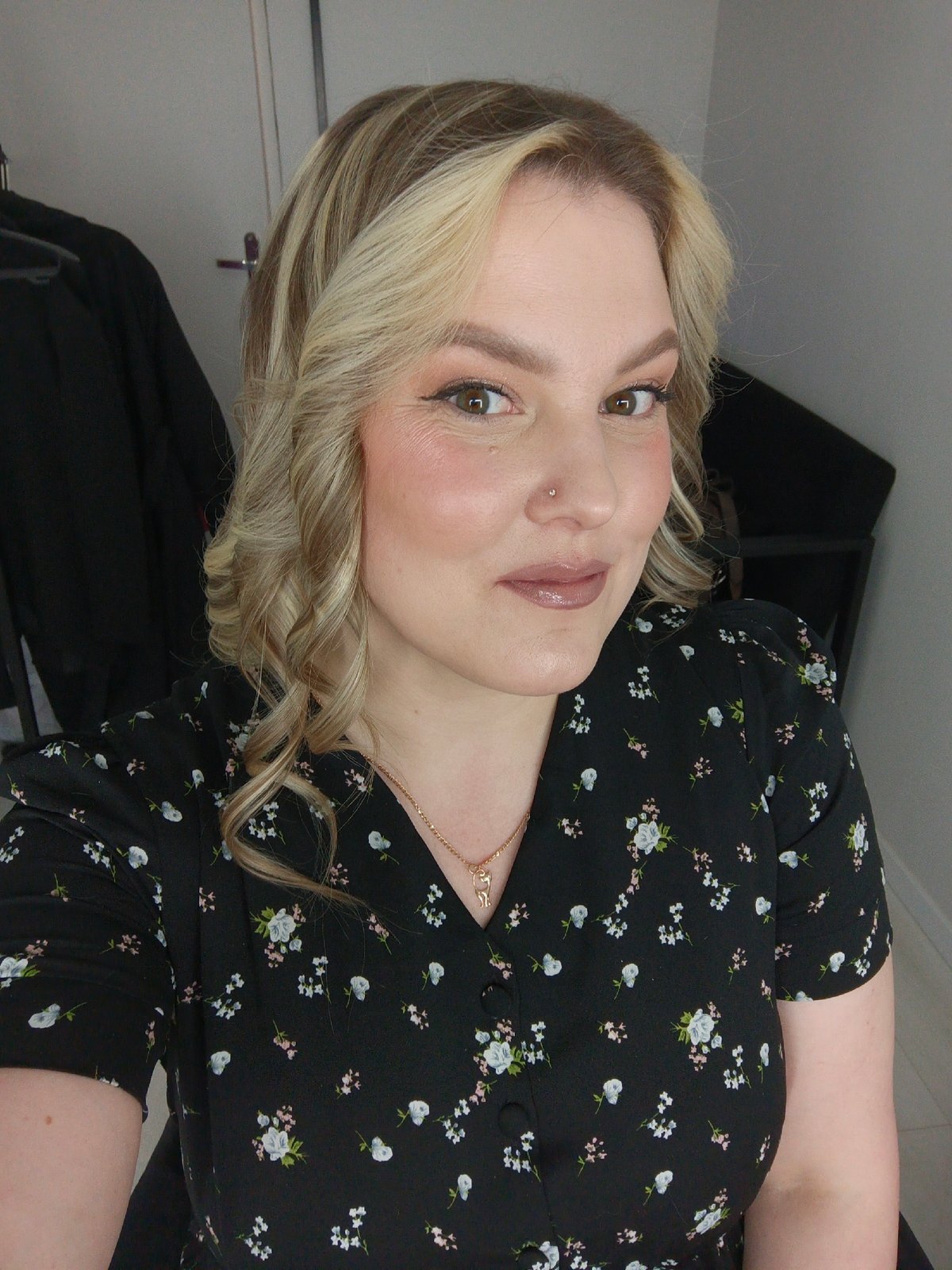 Woman poses for portrait photos in blonde hair, makeup