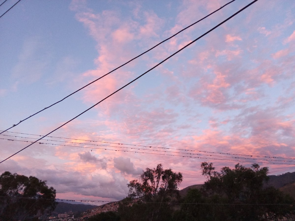 Sunset observed over Caracas with pink-tinted clouds