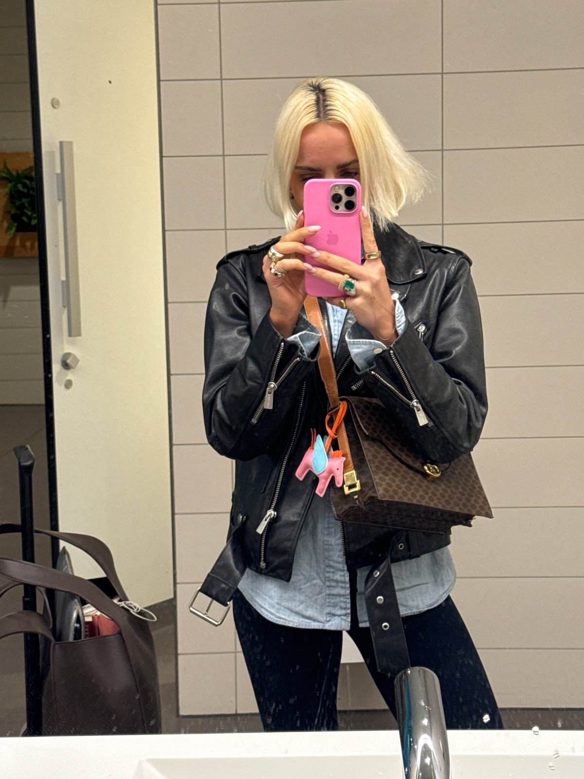 Woman photographs herself and accessories at Gardermoen airport