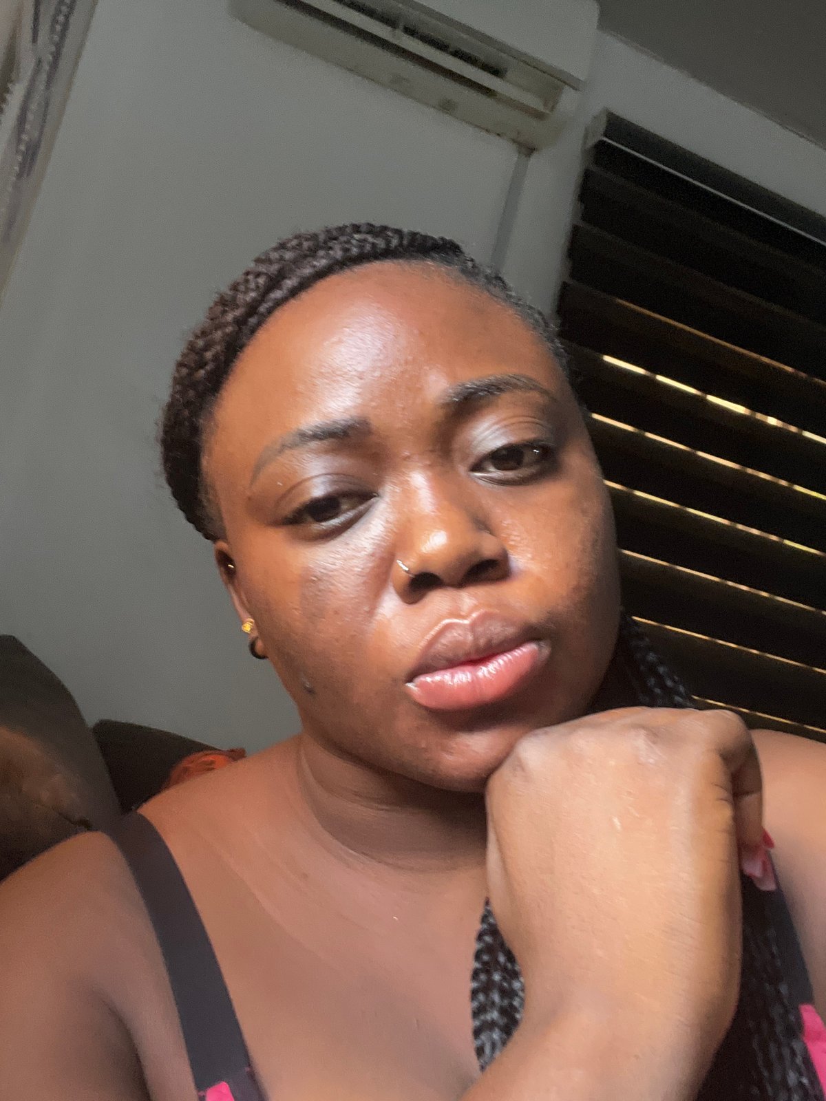 Woman takes morning selfies in Abuja bedroom