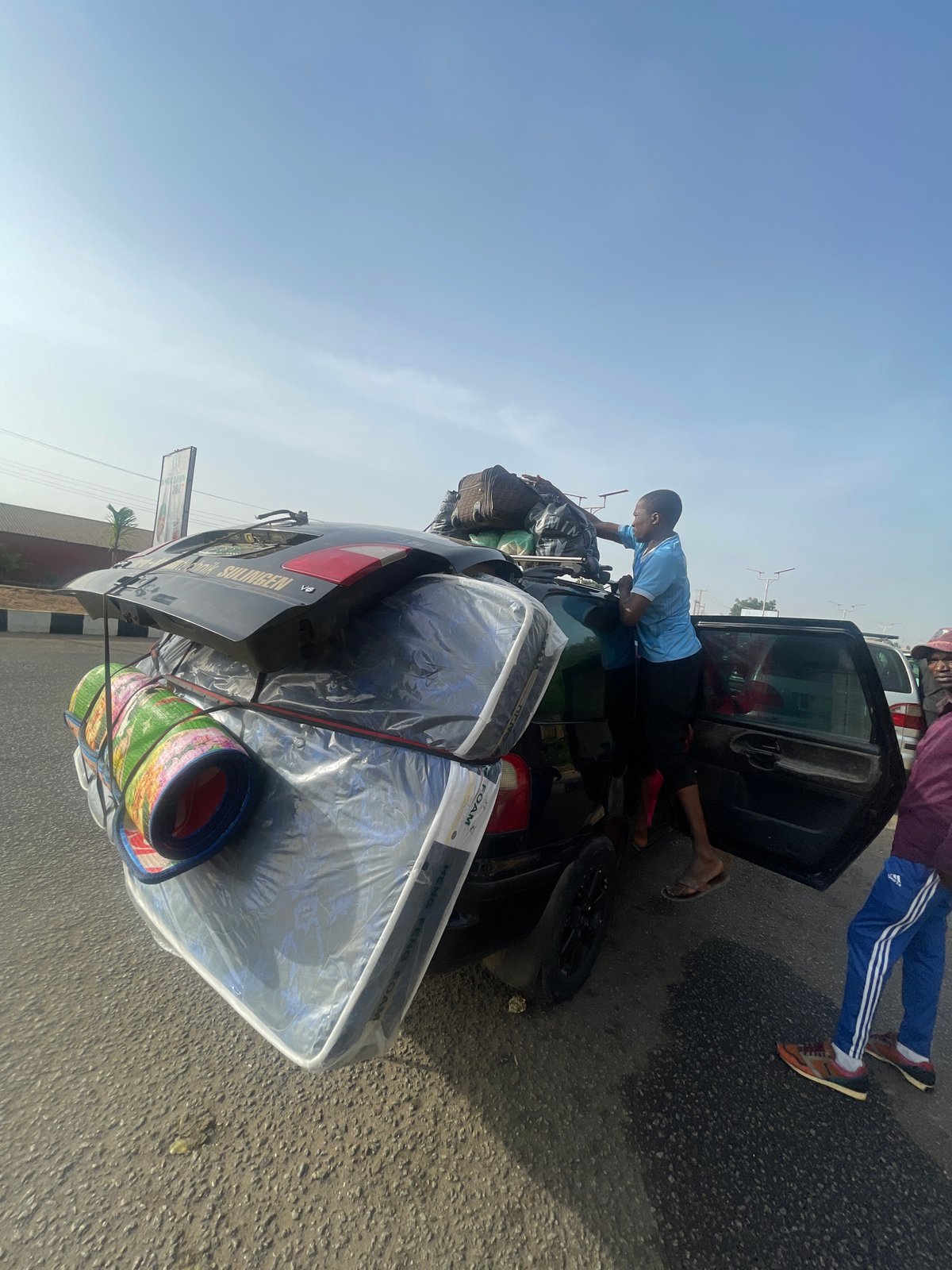 Overloaded car with belongings spotted near Jos monument